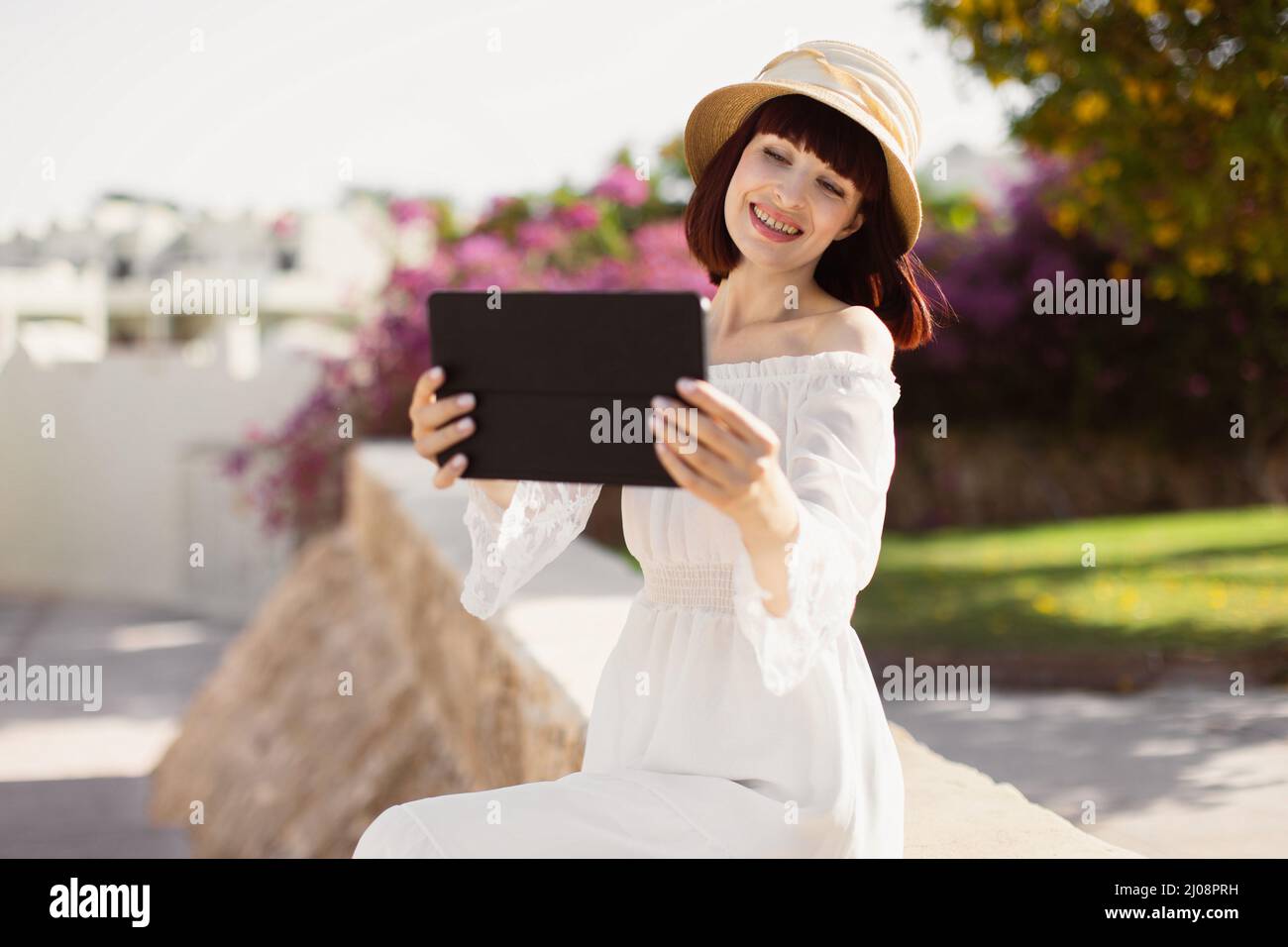 Attractive young woman tourist speaking using tablet, always-on ...