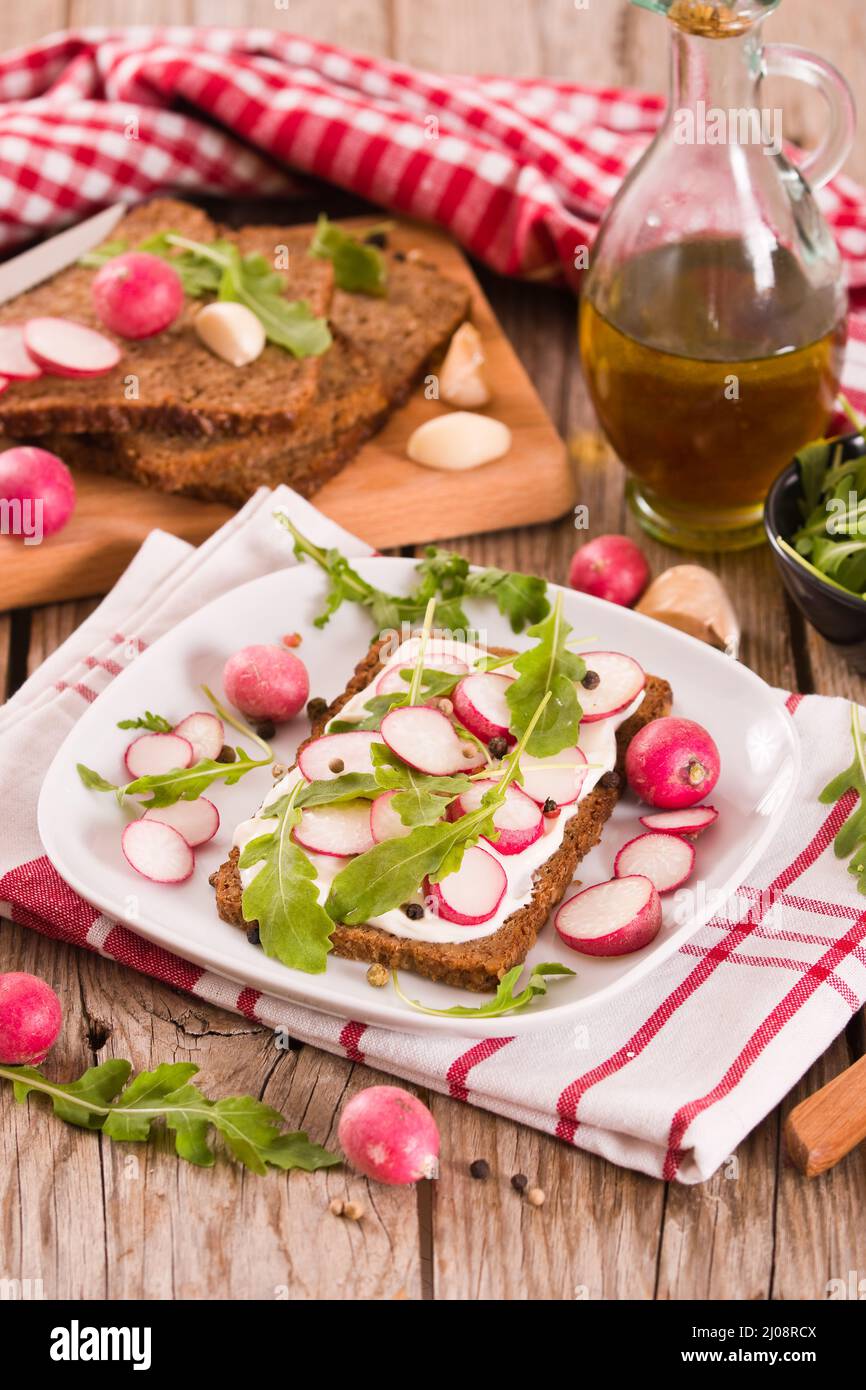 Rye bread with cottage cheese, radish and arugula Stock Photo Alamy