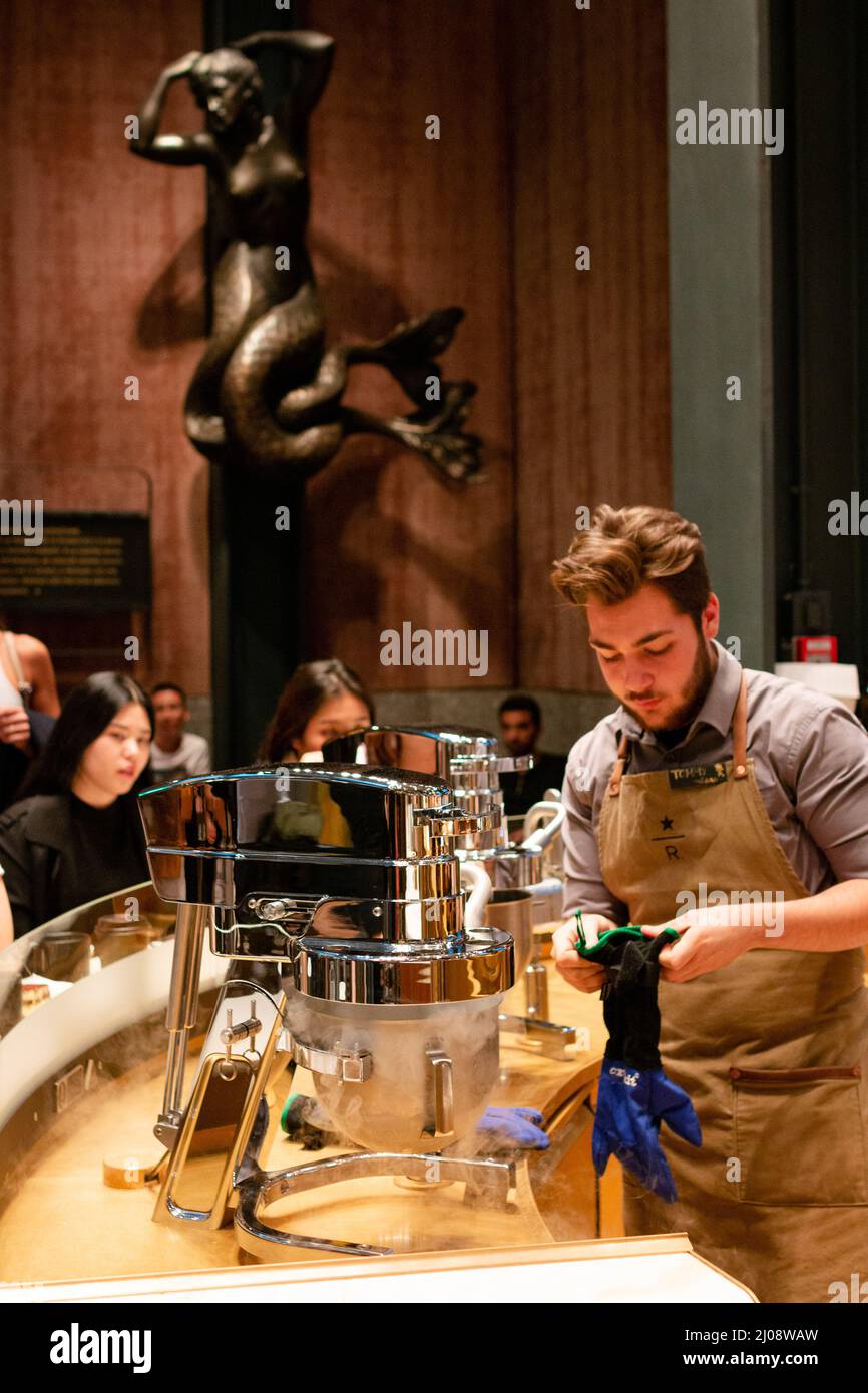 Milan, Italy. 03rd Oct, 2019. A Starbucks Barista prepares an affogato for a customer. Customers line up to order drinks at the Starbucks Reserve Roastery in Milan, Italy on October 3, 2018. Starbucks opened their very first Italian location in the form of the grand Starbucks Reserve Roastery, one of six in the world, in September 2018. It is located at Piazza Cordusio in Milan, Italy. (Photo by Alexander Pohl/Sipa USA) Credit: Sipa USA/Alamy Live News Stock Photo