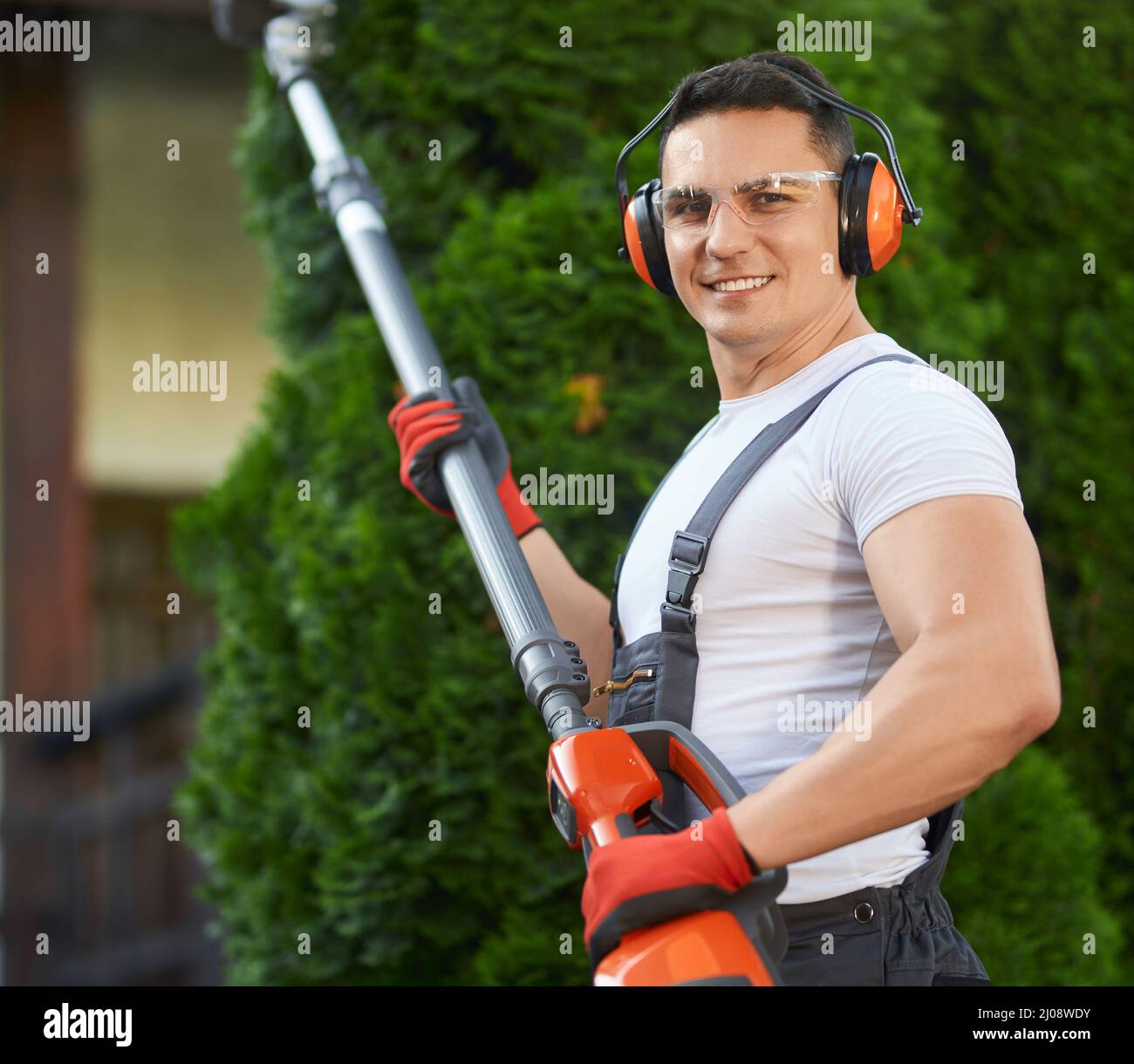 Portrait of strong caucasian man in overalls, safety glasses