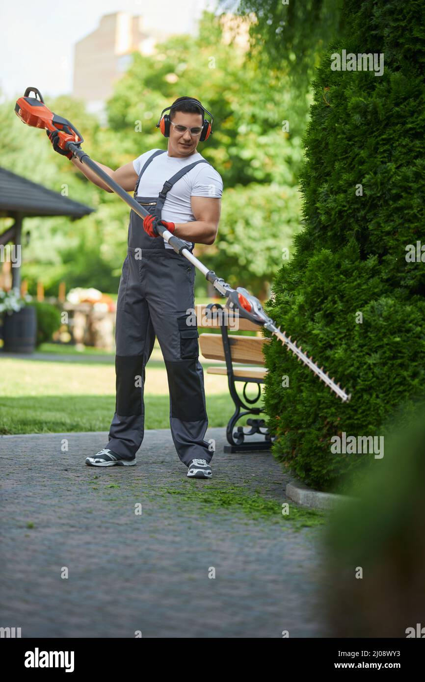 Full length portrait of caucasian man wearing overalls, safety glasses