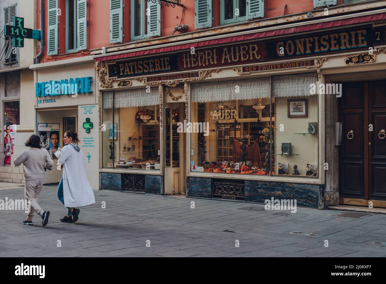 Nice, France - March 10, 2022: Exterior of La Maison Auer, a family owned Chocolaterie and Confiserie in Nice dating back to 1820, women walking past. Stock Photo