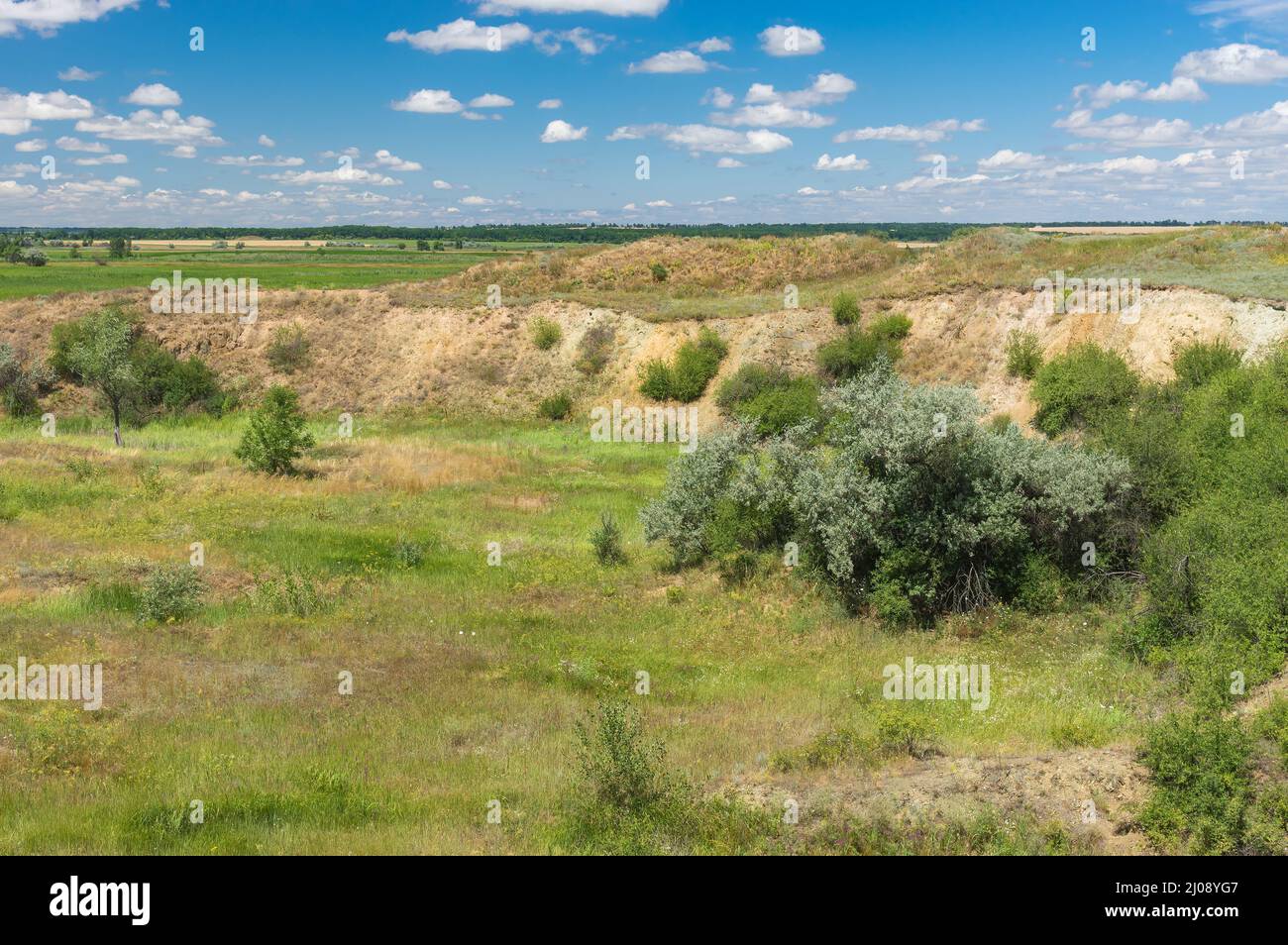Summer landscape with overgrown crater of extinct volcano located near small river Sura in Apollonivka village, central Ukraine Stock Photo
