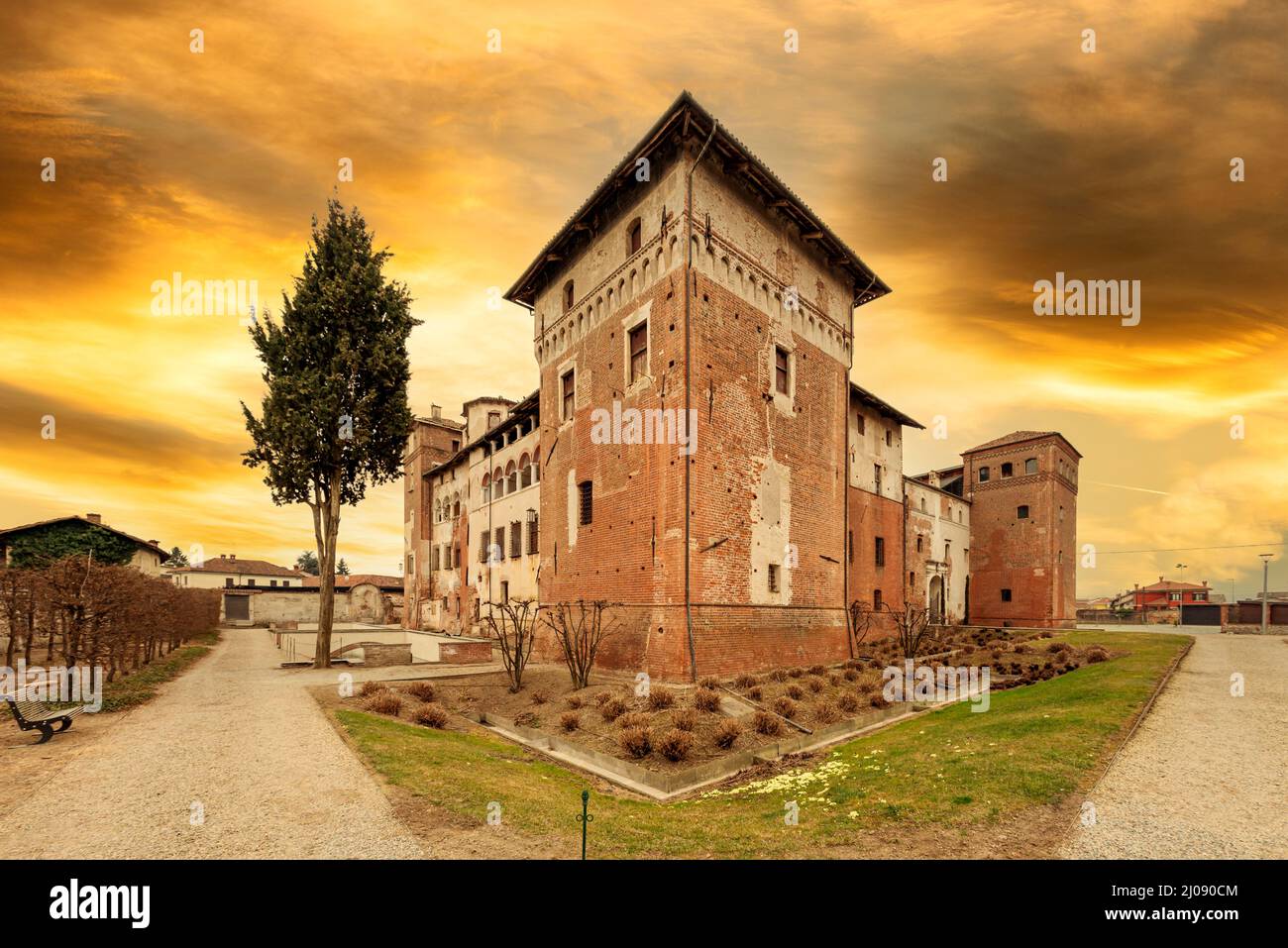Lagnasco, Cuneo, Italy - March 16, 2022: The Castles of the Marquises Tapparelli D'Azeglio (11th to 18th century) with sky with colored sunset clouds Stock Photo