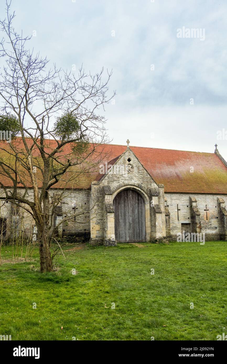UK, England, Somerset, Pilton village. 12th century Tithe Barn was restored by Michael Evis of Worthy Farm & Glastonbury Festival. Stock Photo