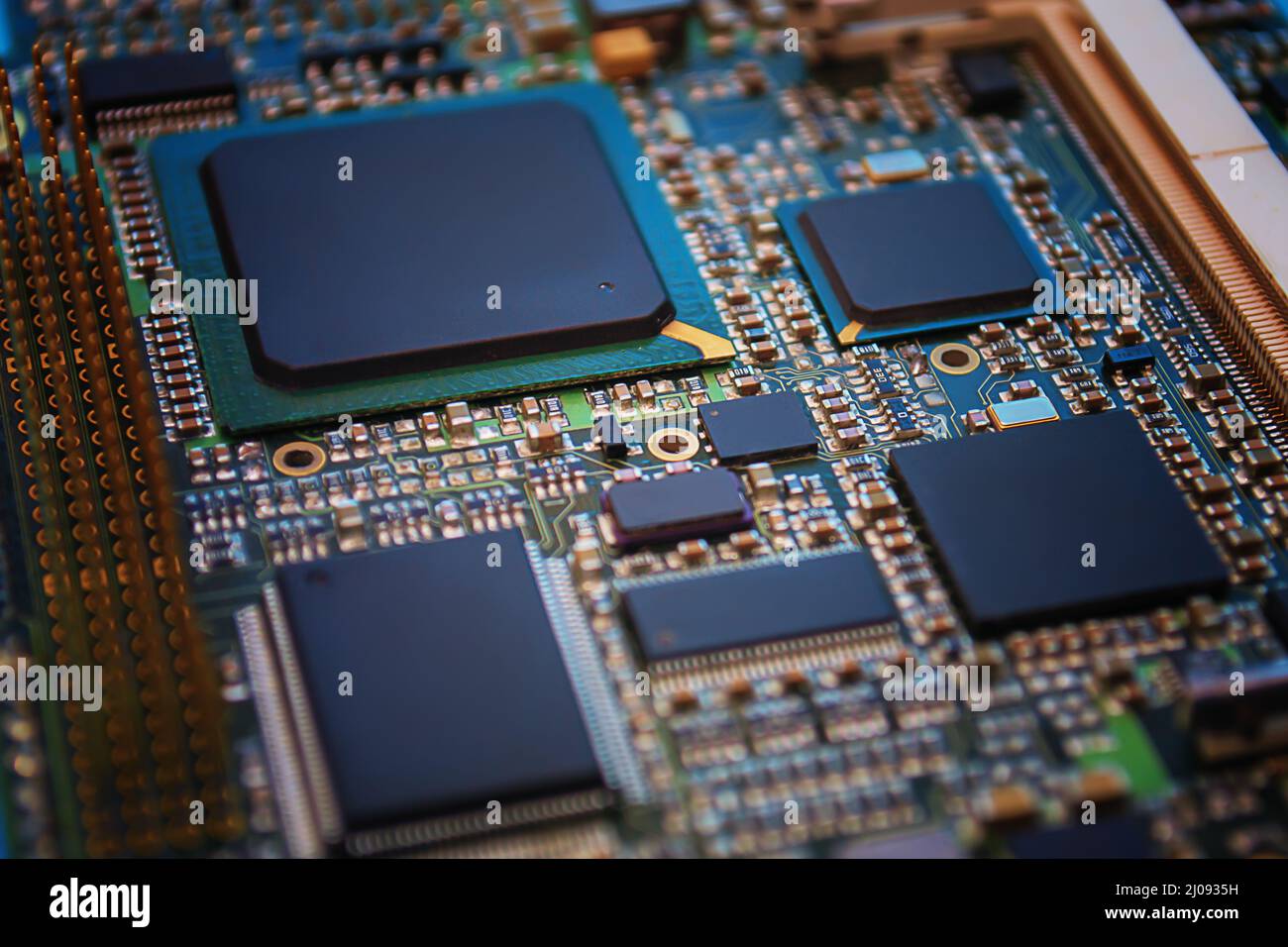 Closeup of Printed Circuit Board with  integrated circuits and many other passive electrical components. Stock Photo