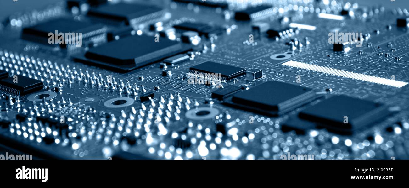 Closeup of Printed Circuit Board with  integrated circuits and many other passive electrical components. Stock Photo