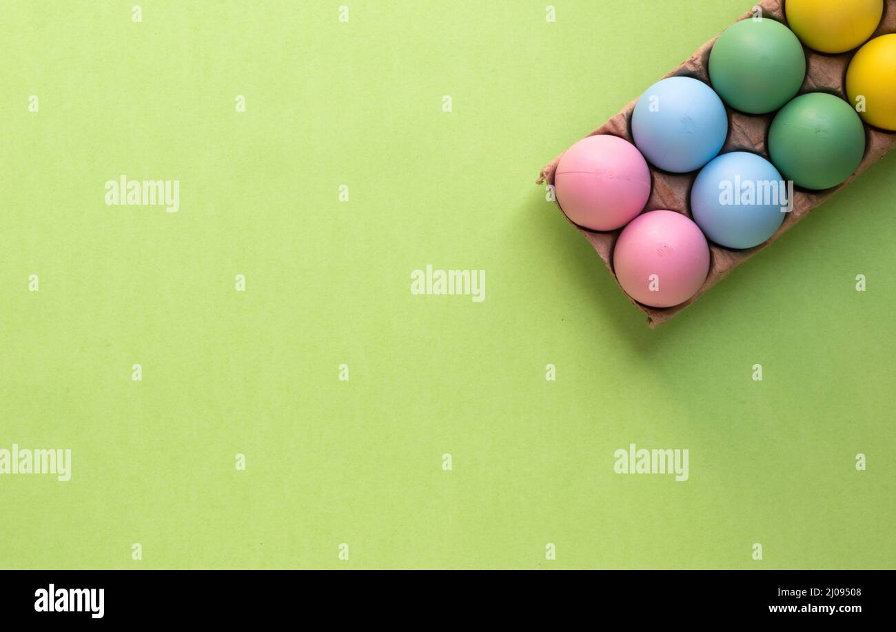 Easter wallpaper background. Colorful easter eggs in egg carton Stock Photo