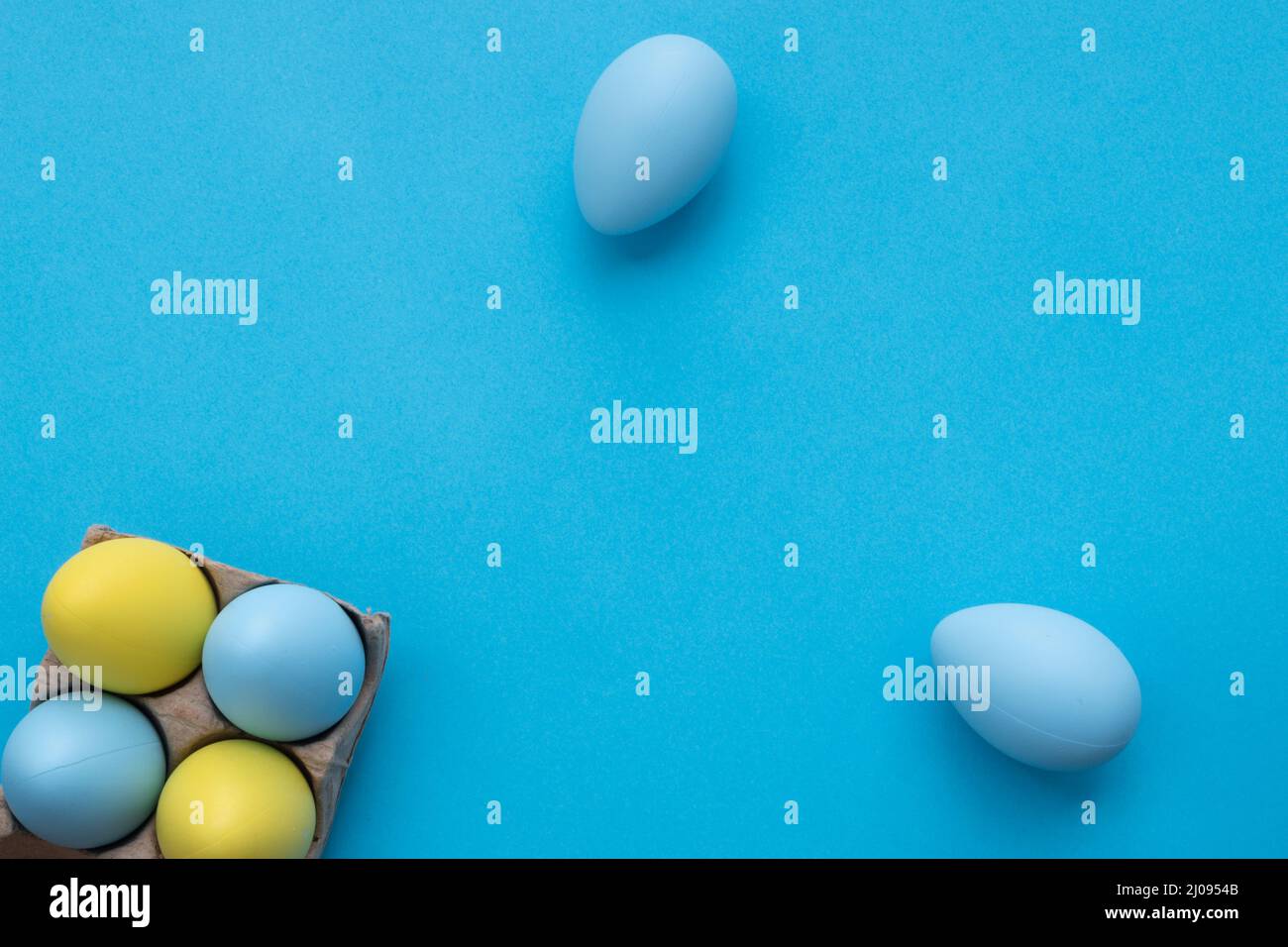 Easter wallpaper. Simply easter composition with blue and yellow eggs. Copy space. Stock Photo