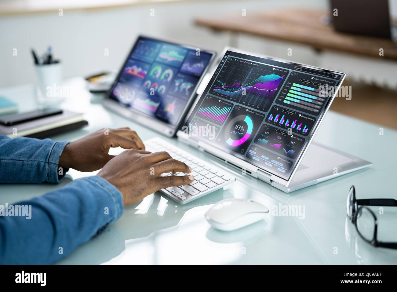 African Advisor Using KPI Dashboard With Financial Analytics Graphs Stock Photo