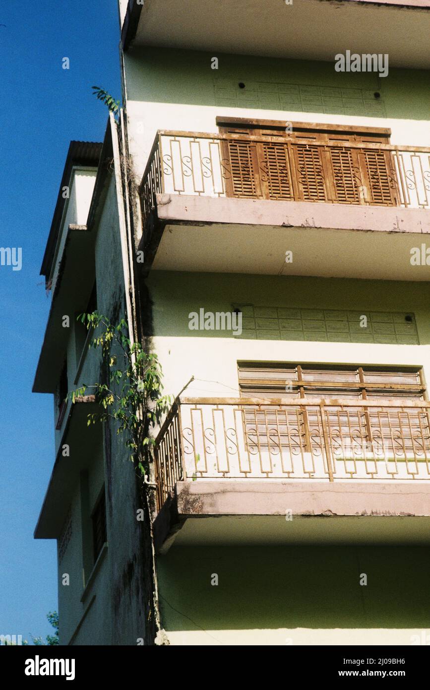 Low angle shot of a facade of an old building with rusty windows and ...