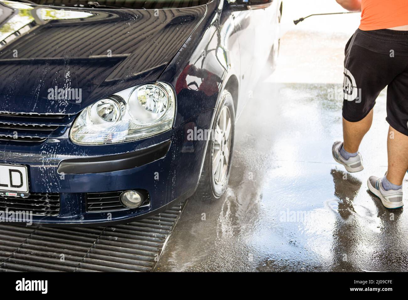 Female person hand with sponge scrubbing vehicle with foam, car wash. Young  woman on self-service automobile washing. Outdoor carwash Stock Photo -  Alamy