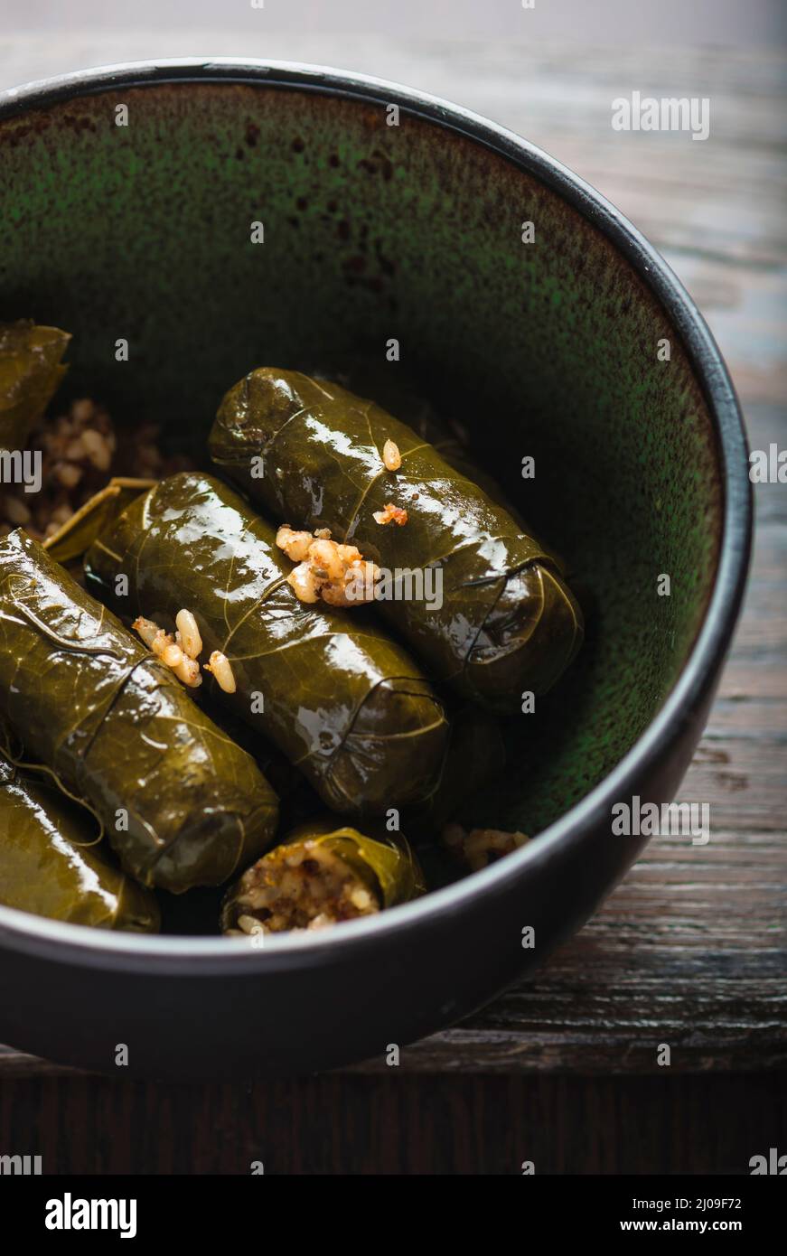 Stuffed vine leaves, or Dolmades, in a bowl. Close up. Vine leaves with stuffed rice. Middle eastern traditional food and cuisine. Stock Photo