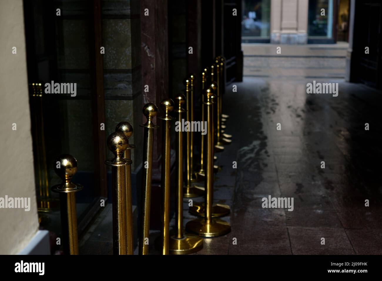 doorway in the city and gilt fence posts, wet pavement Stock Photo Alamy