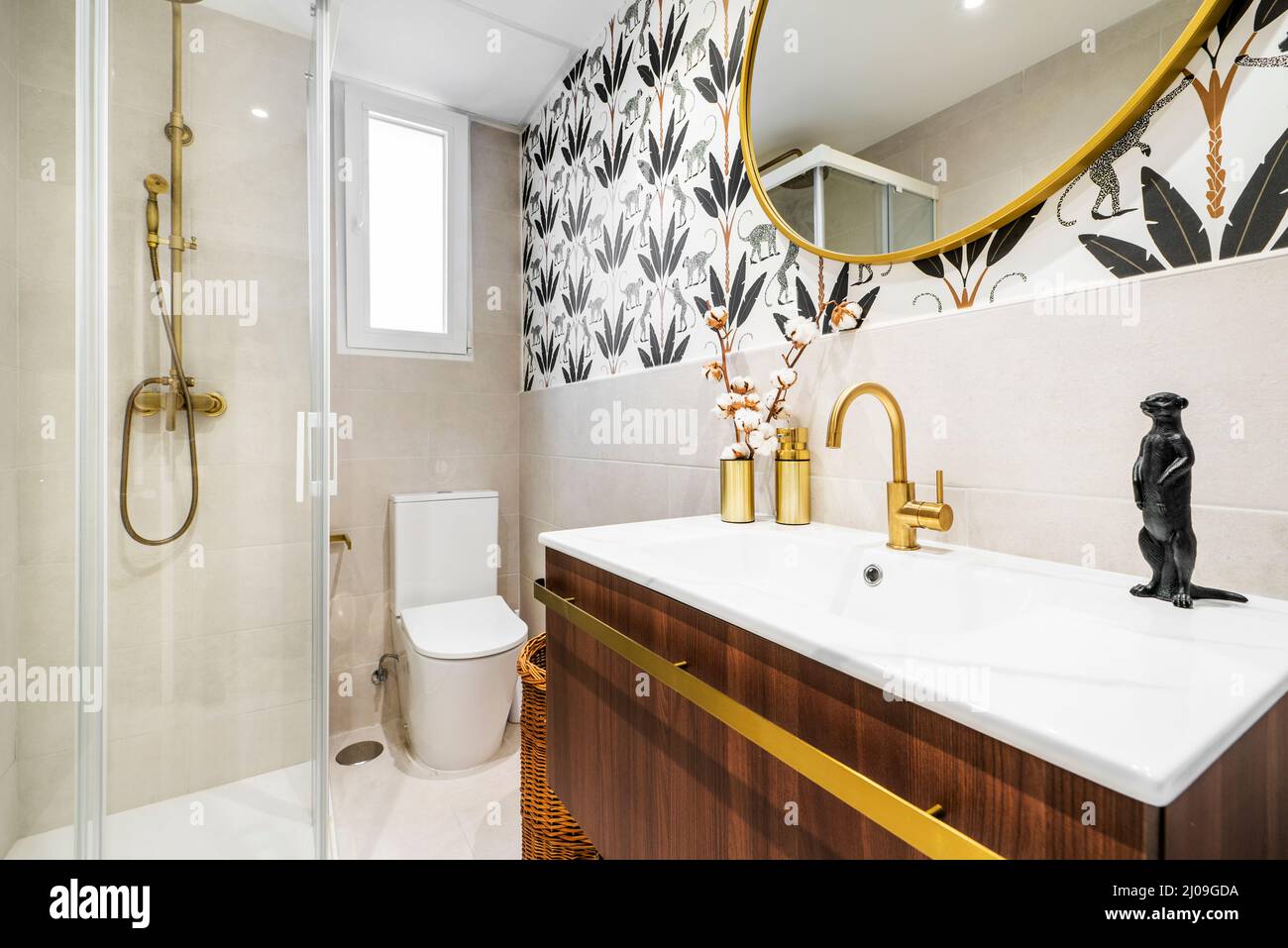 Tiled toilet with large cream tiles, gold faucets, Egyptian cotton