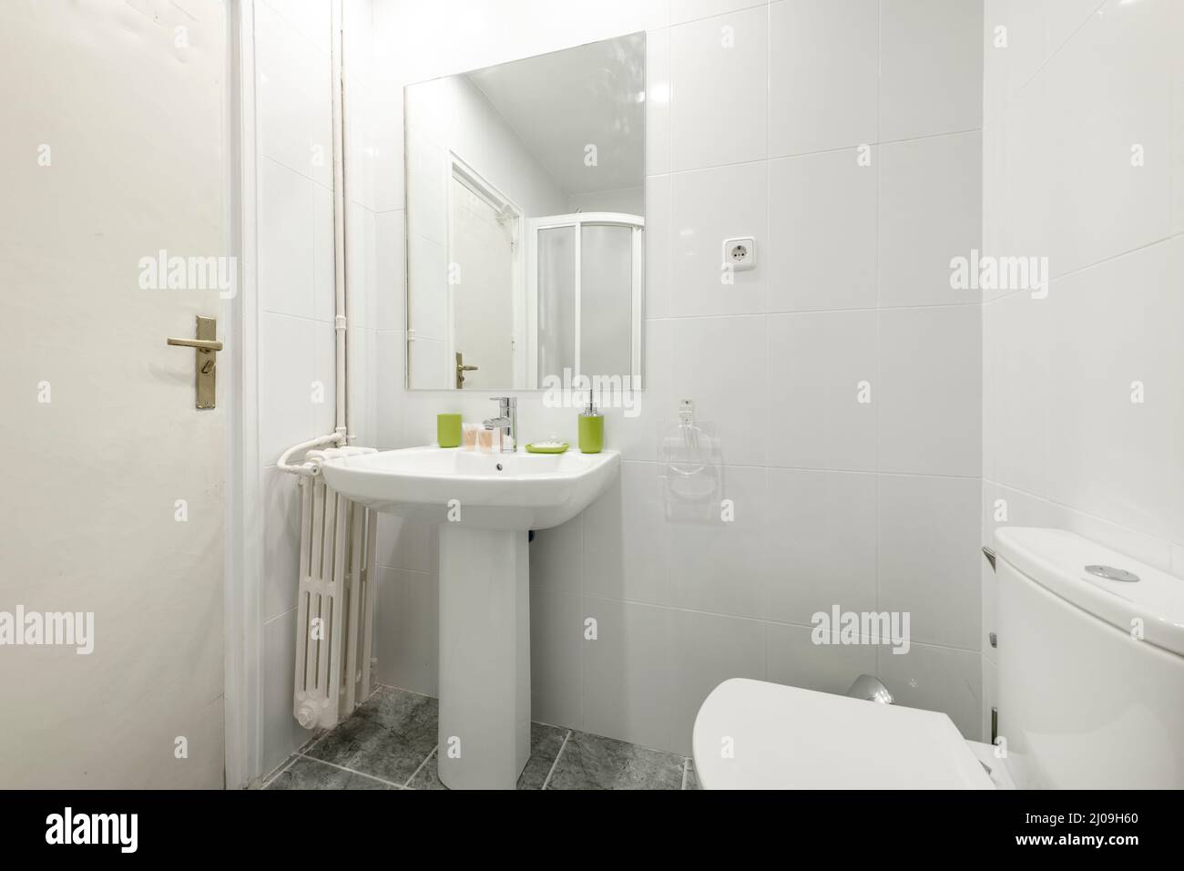 Bathroom with matching pedestal white porcelain sink, square frameless