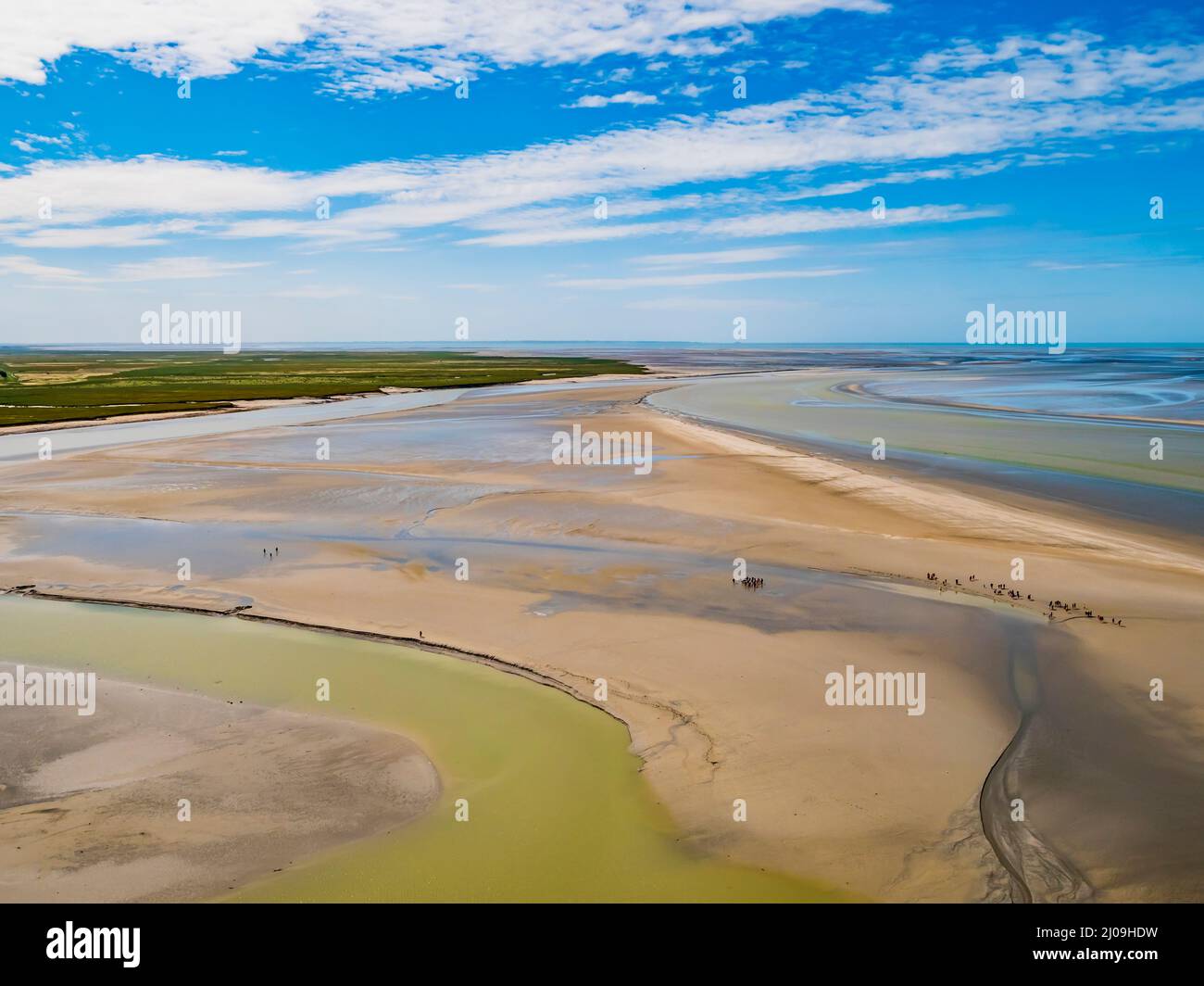 Le Mont Saint Michel, impressive view of the colourful sand flats surrounding the famous abbey during low tide, Normandy, Northern France Stock Photo