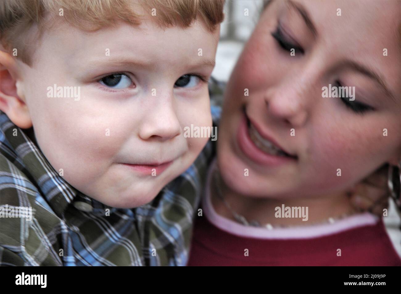 Kids at family gathering Older sister and youngest brother who are