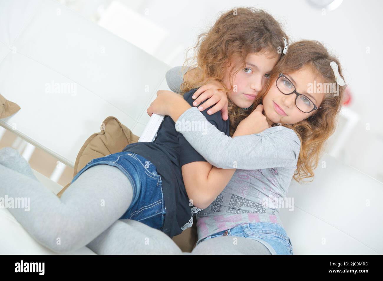 two girls are cuddling together Stock Photo - Alamy