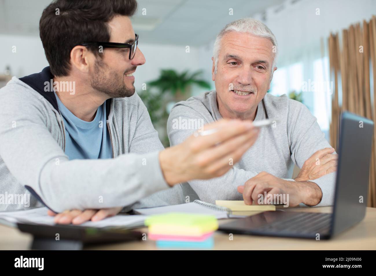 different generations 60s and man using pc Stock Photo