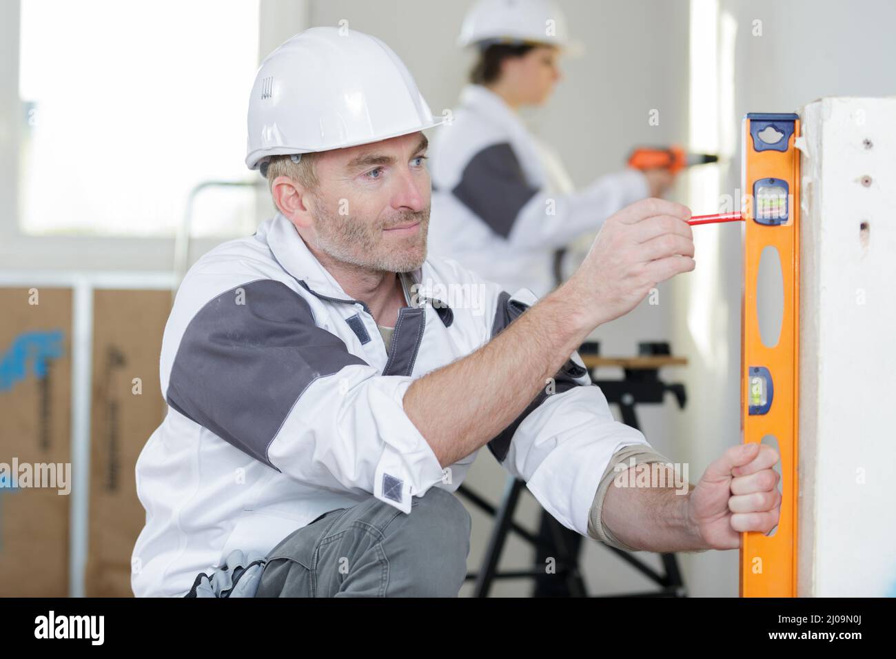 construction worker with spirit level Stock Photo - Alamy