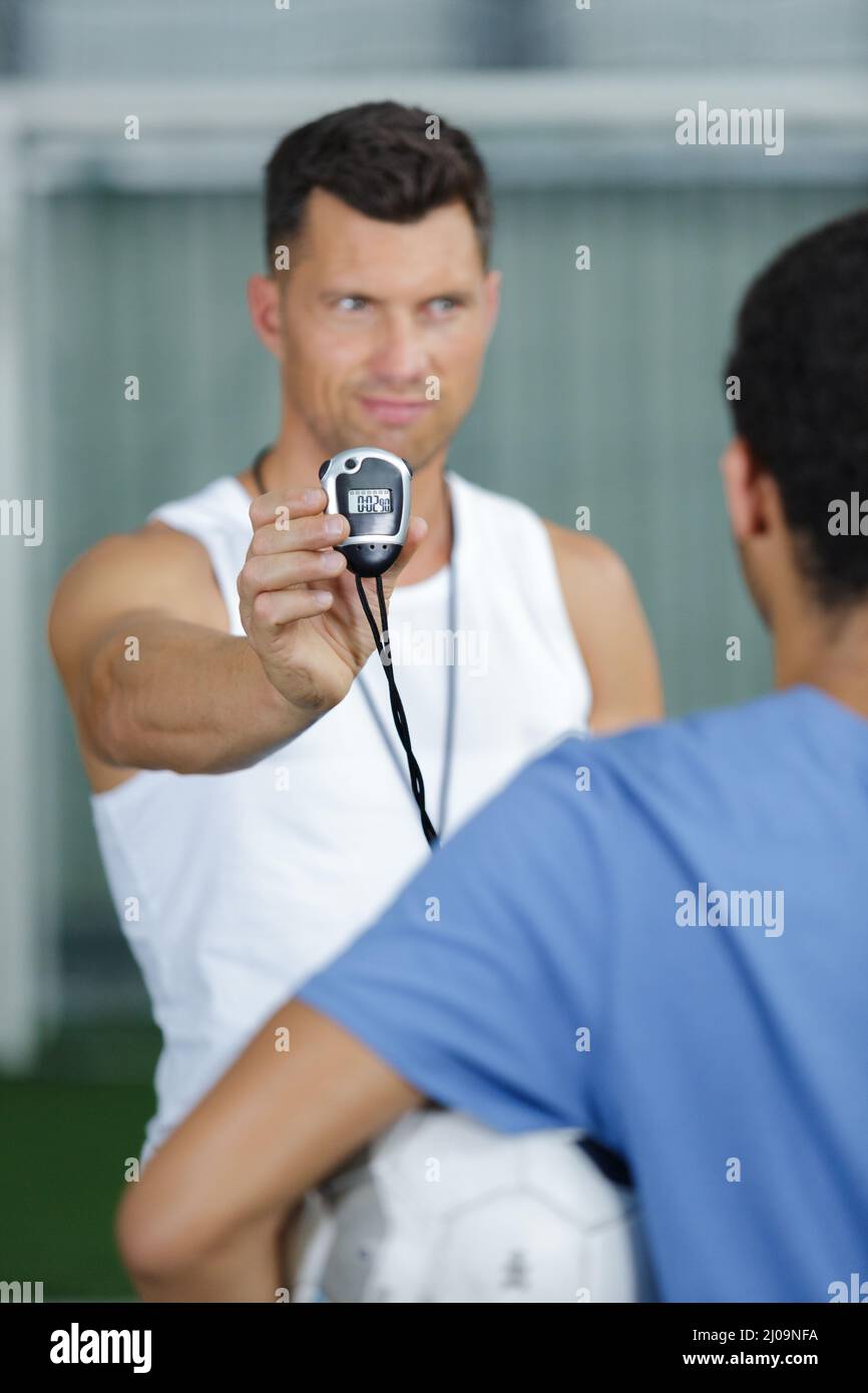 handsome personal trainer with stopwatch Stock Photo Alamy