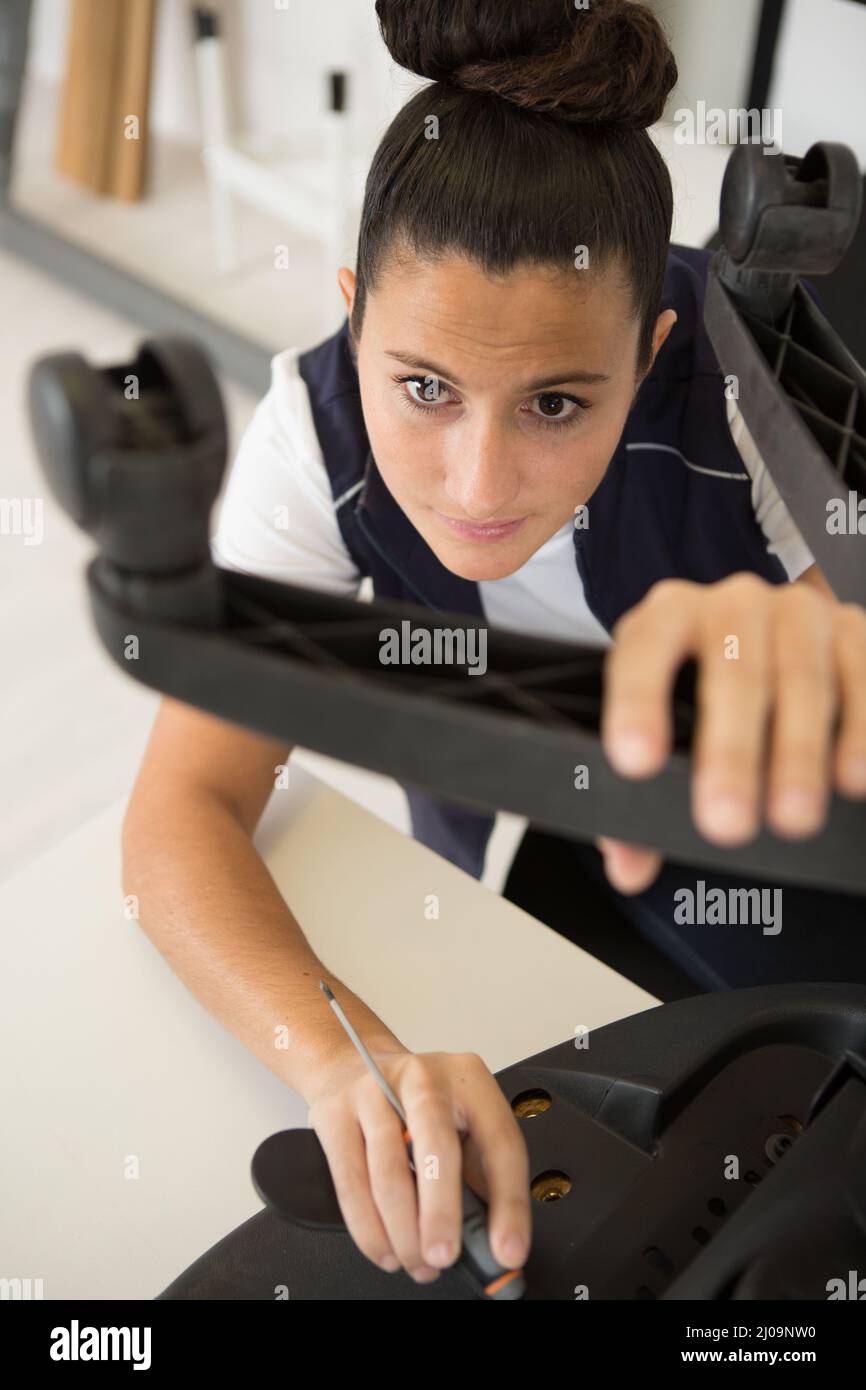 woman assembling office chair using screwdriver Stock Photo Alamy