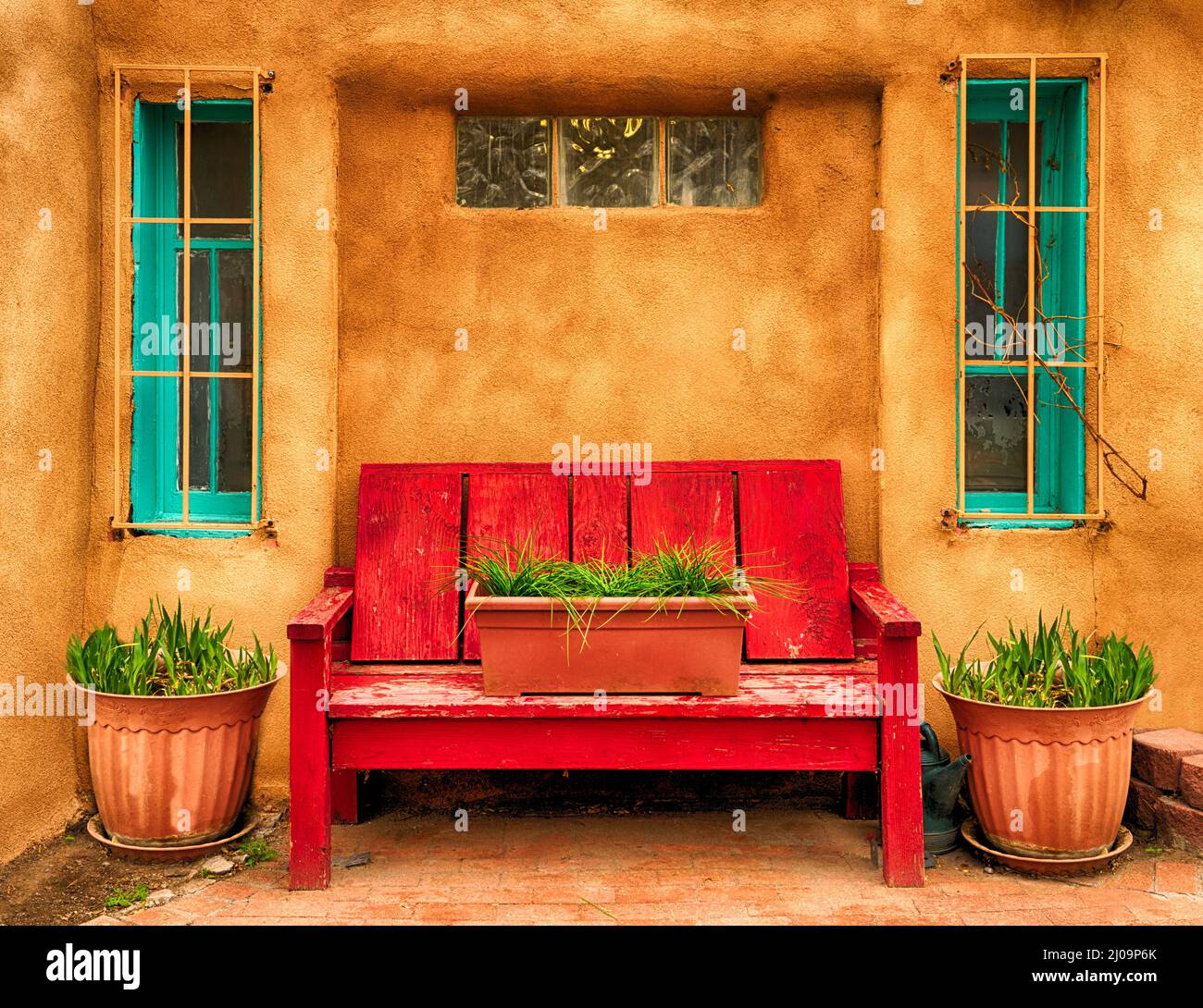 A bright red bench in "Old Town" Albuquerque, New Mexico Stock Photo