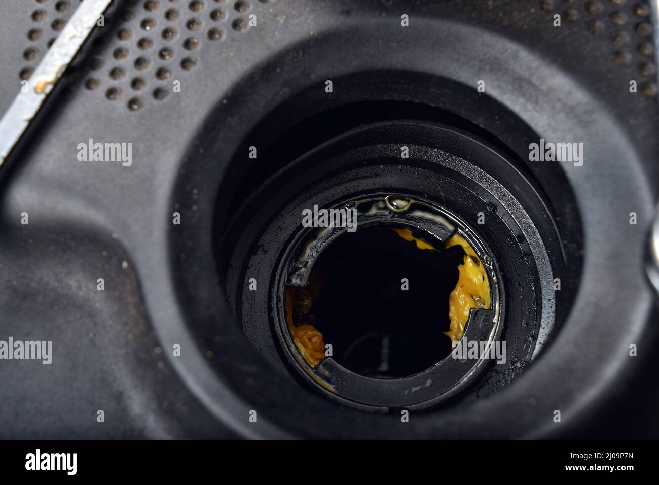 The thick, greasy yellow motor oil under oil cap as signs and symptom