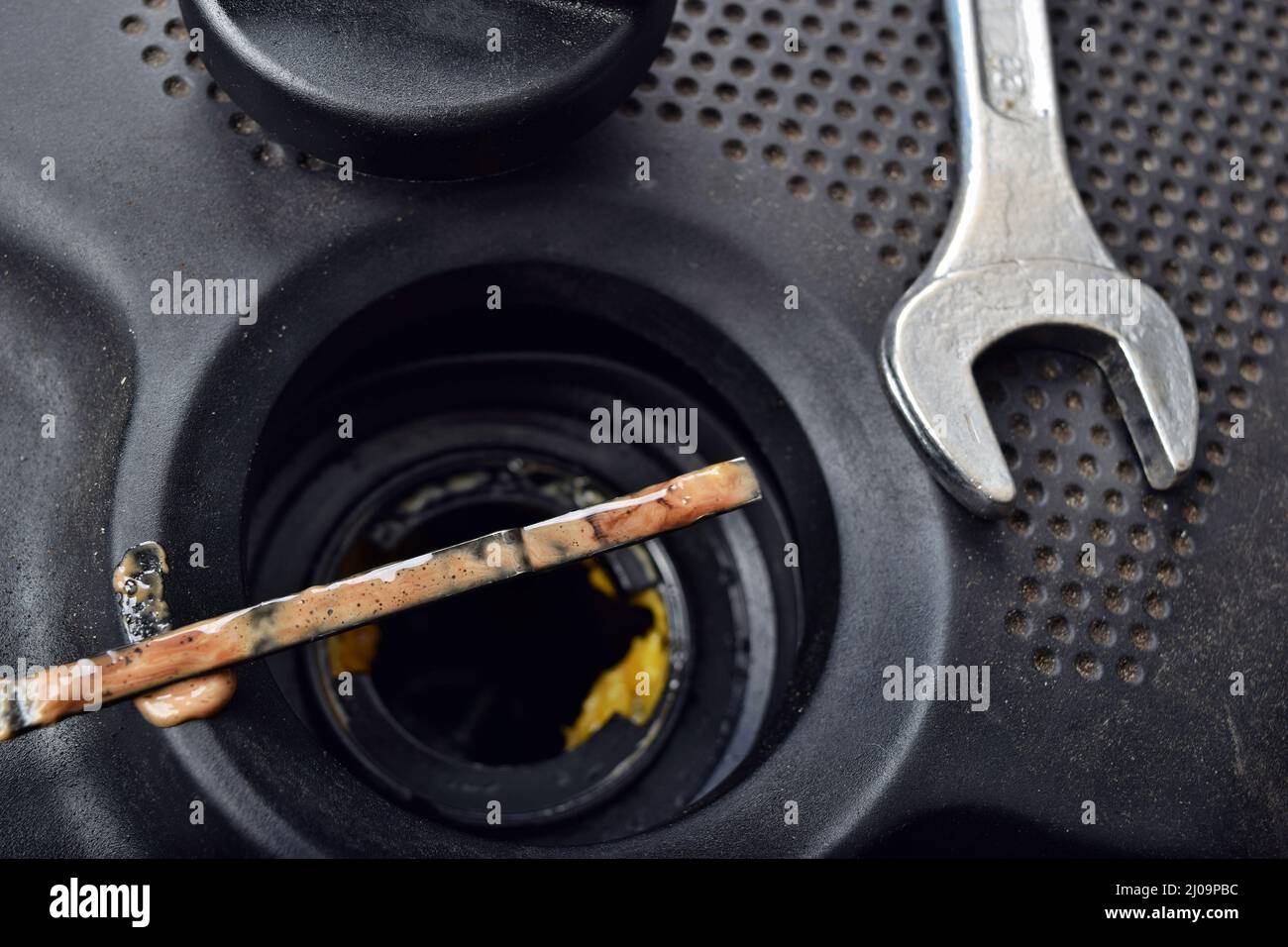 The thick, greasy yellow motor oil under oil cap as signs and symptom