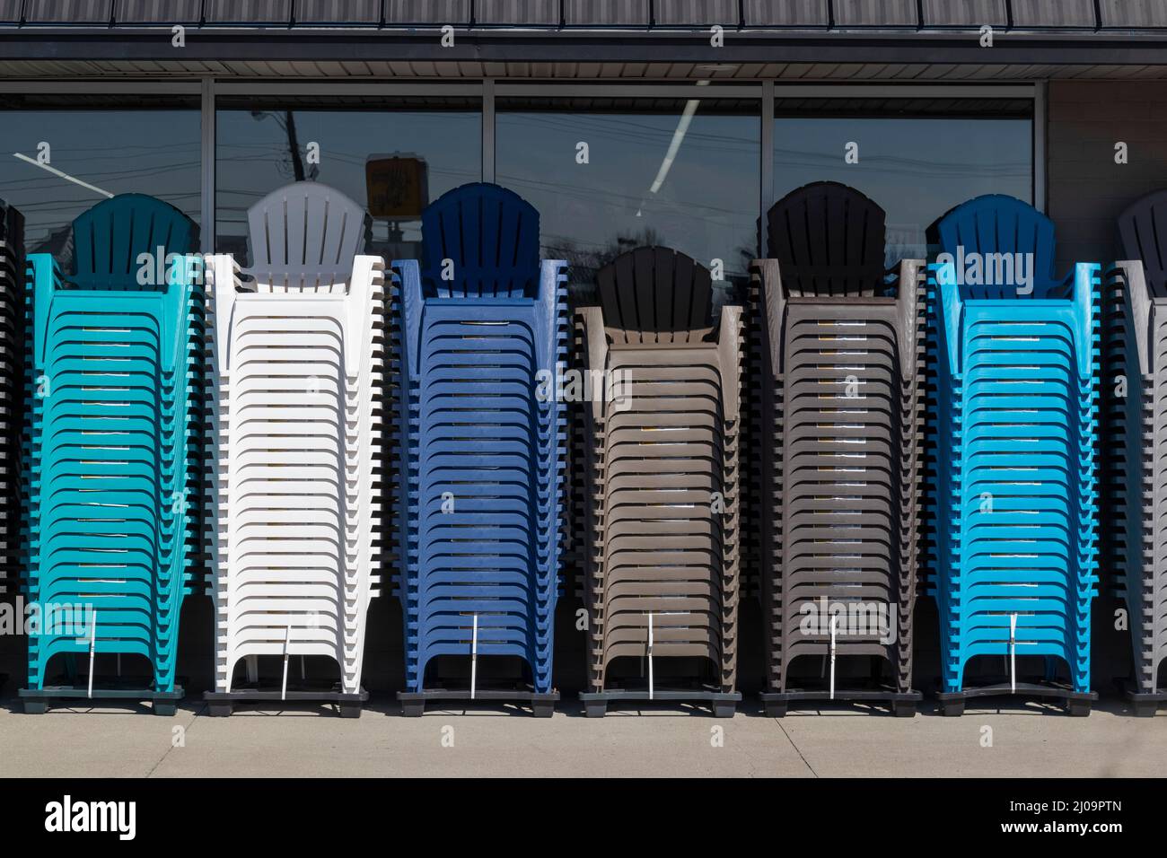 Adirondack Chairs of different colors stacked outside a retailer