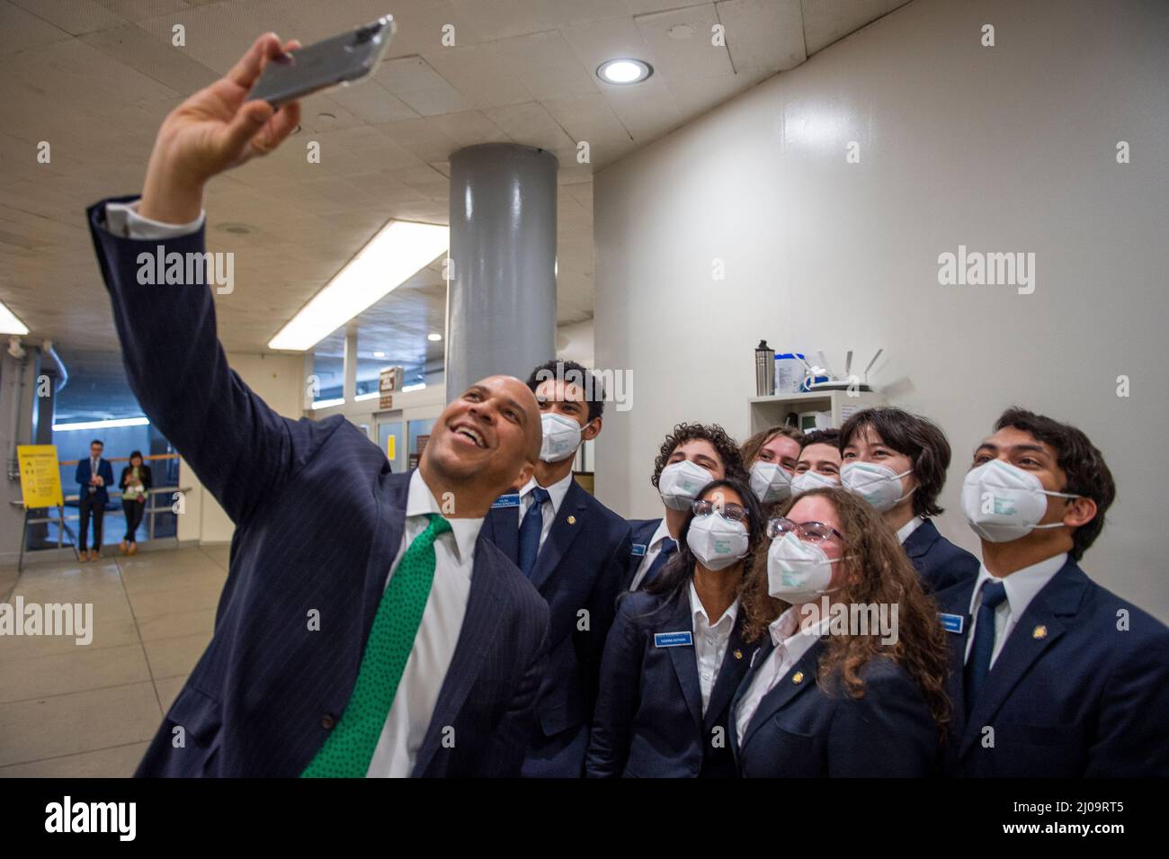 Washington, United States Of America. 17th Mar, 2022. United States Senator Cory Booker (Democrat of New Jersey) takes a moment for a selfie photo with a group of pages in the Senate subway at the US Capitol during a vote in Washington, DC, Thursday, March 17, 2022. Credit: Rod Lamkey/CNP/Sipa USA Credit: Sipa USA/Alamy Live News Stock Photo