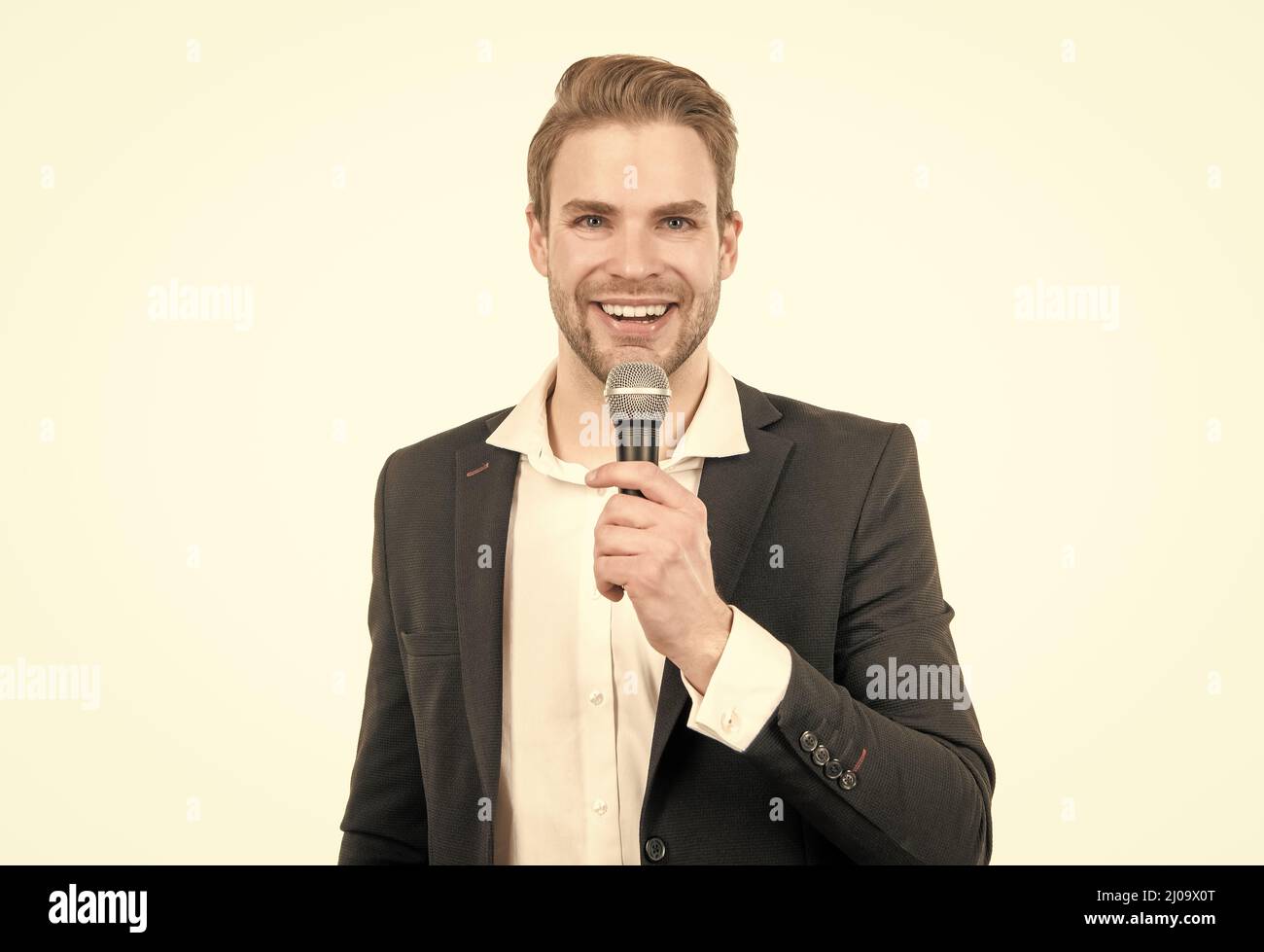 Happy man in business formalwear speak into microphone giving speech isolated on white, conferencier Stock Photo