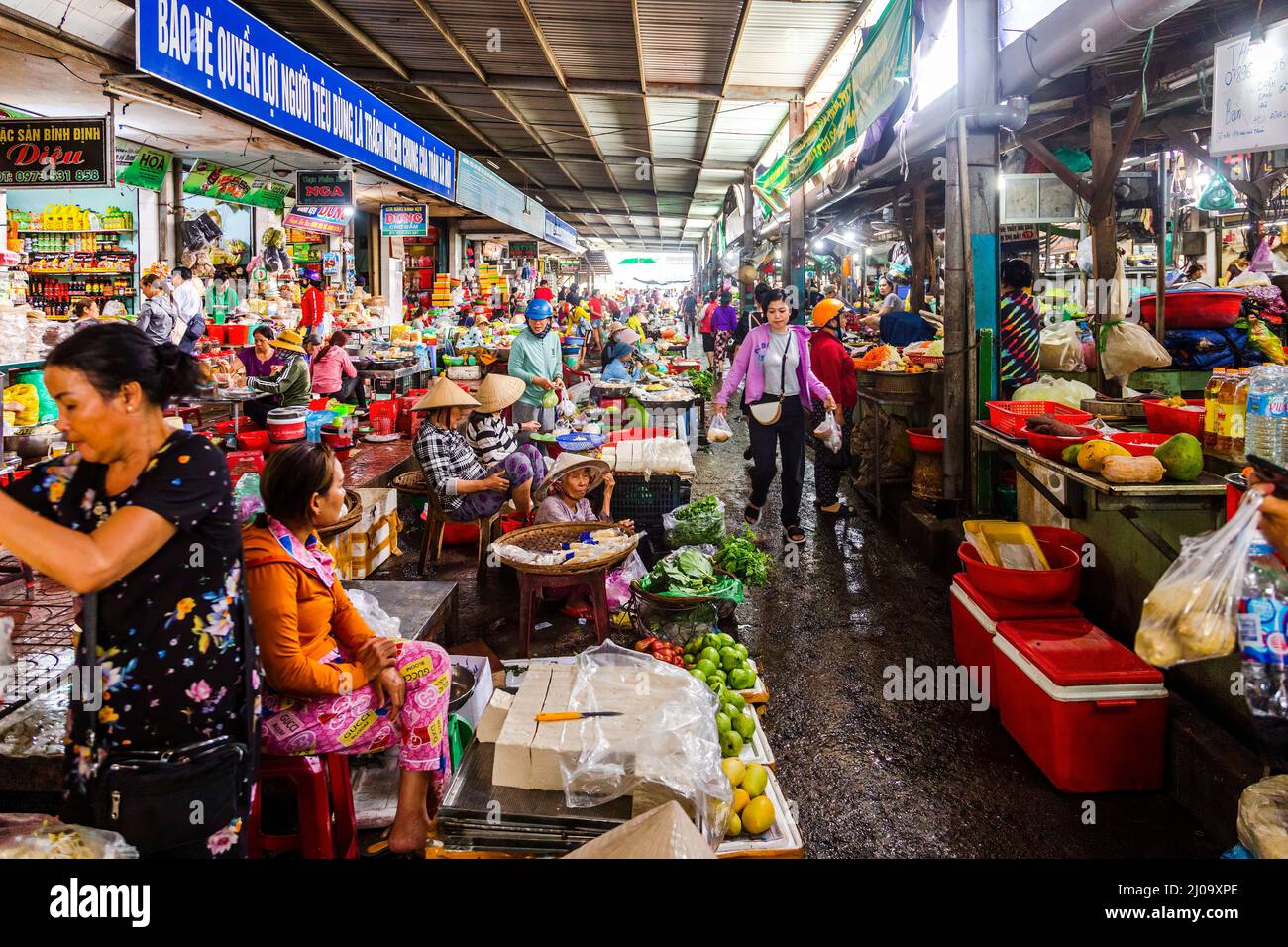 Inside a large food market with many people and a large amount of food
