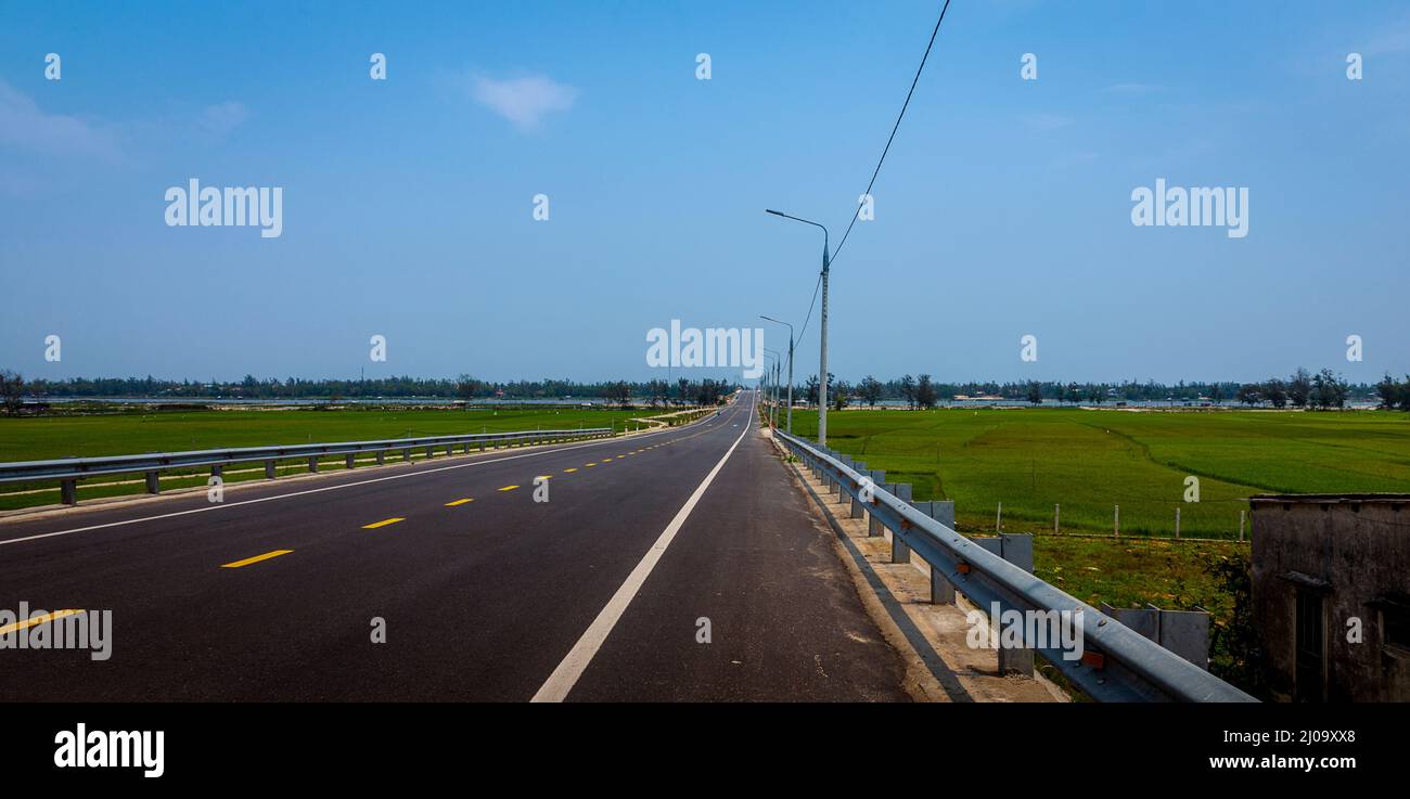 A nice two lane highway in Tan Thanh, Vietnam with no traffic. Stock Photo