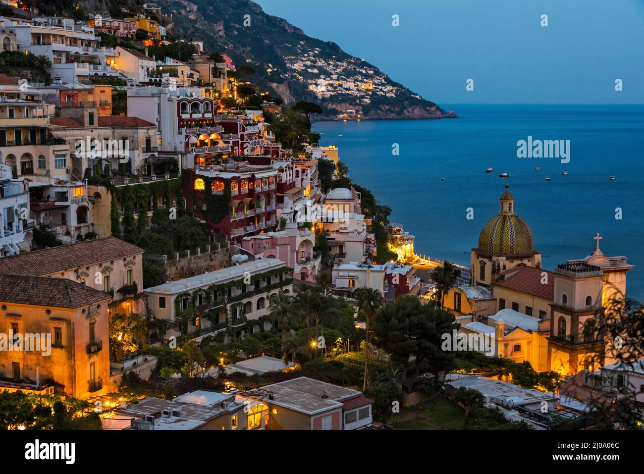 Sunset view of Church of Santa Maria Assunta and houses of Positano along the Amalfi Coast, Salerno Province, Compania Region, Italy Stock Photo