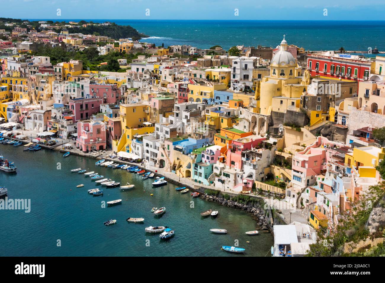 Sanctuary of Santa Maria delle Grazie and colorful houses along the harbor, Procida, Naples, Campania Region, Italy Stock Photo