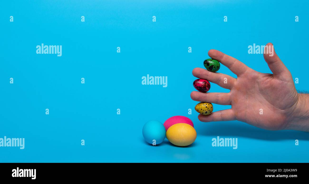 Easter eggs and fingers with quail eggs Stock Photo