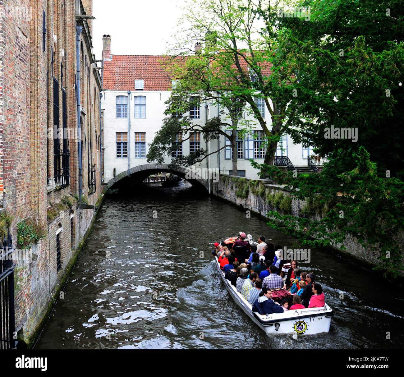 Tourist boats on an inner canal boat trip in Bruges, Belgium. Stock Photo