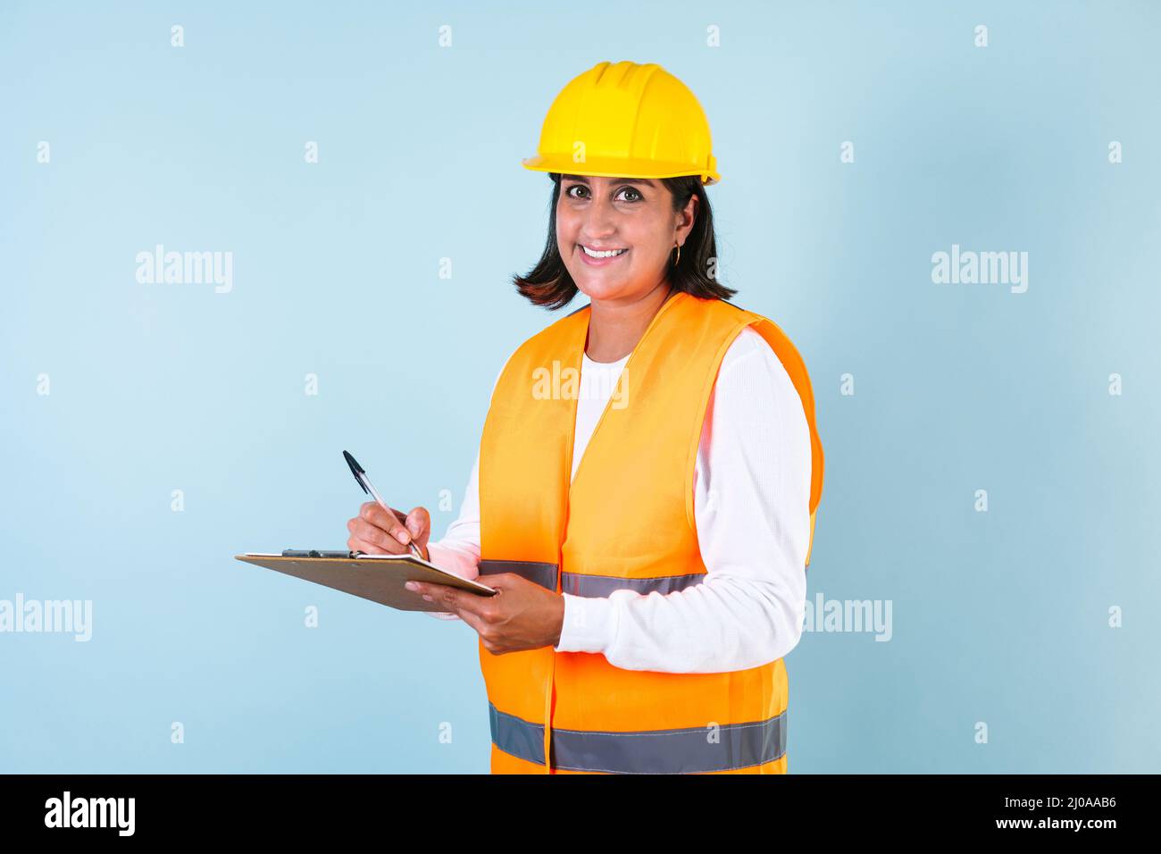 Hispanic woman Professional engineering contractor builder and hard worker with helmet in Mexico Latin America Stock Photo