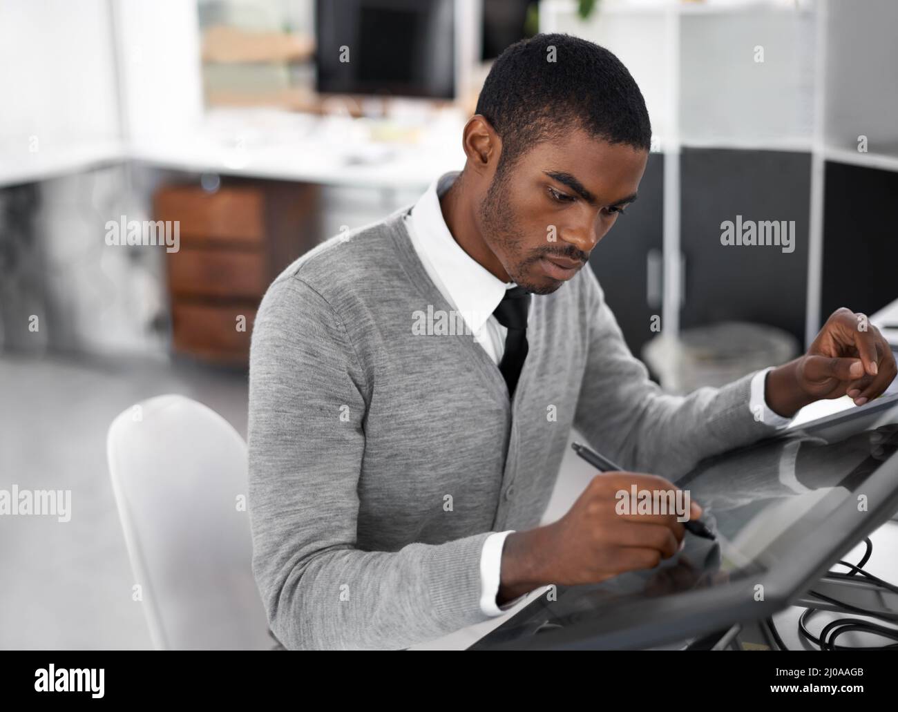 Smart technology makes everything easier. A young man working on a large touchscreen. Stock Photo