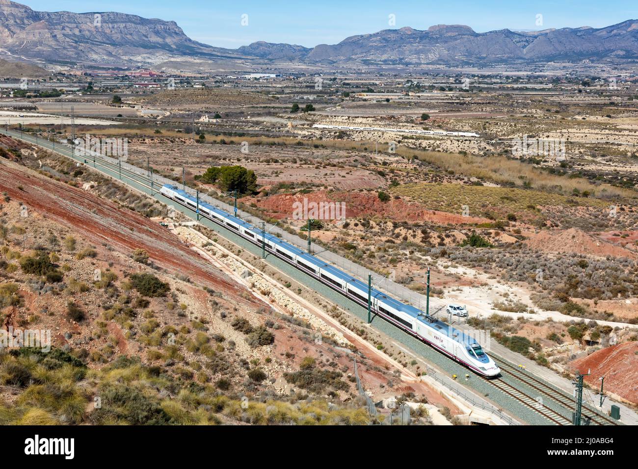 Alicante, Spain - February 16, 2022: Talgo 350 high-speed train of RENFE AVE on the Madrid - Levante high speed rail railway line near Alicante, Spain Stock Photo