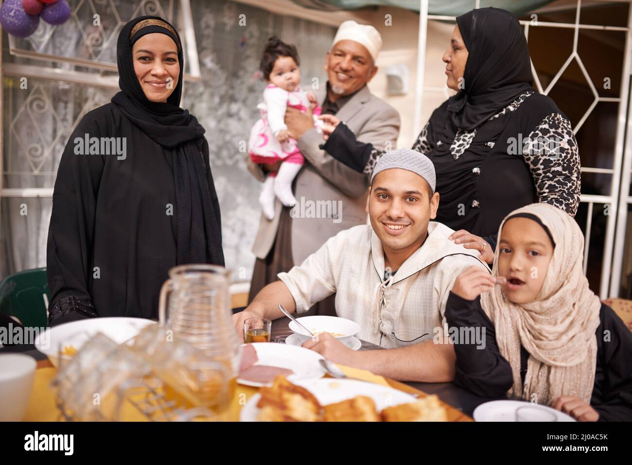 The end of the fast. Shot of a muslim family eating together. Stock Photo
