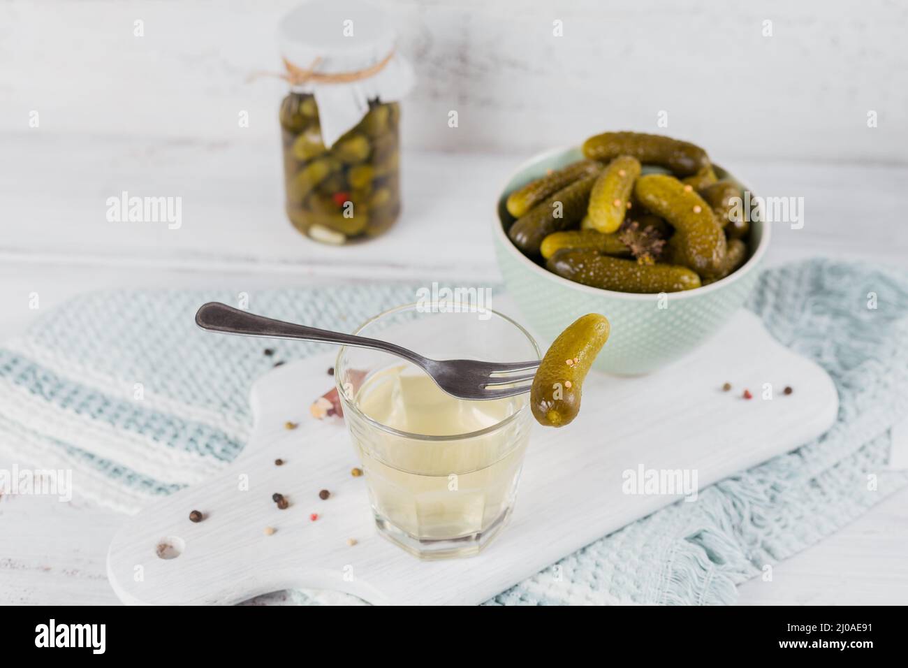 Pickled juice, pickle and marinated cucumber in a bowl. Clean eating, vegetarian food concept Stock Photo