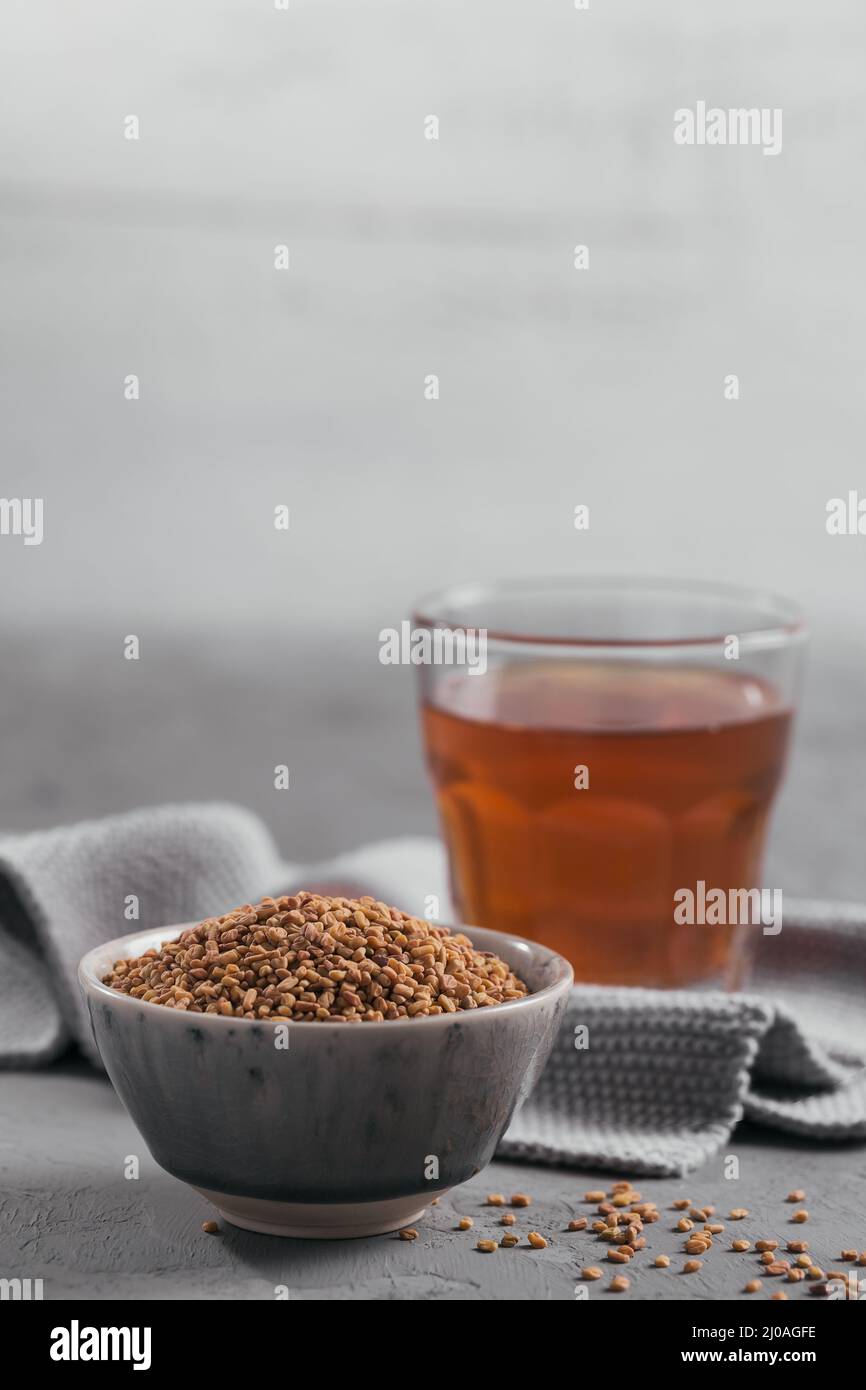 Bowl of fenugreek seeds and Egyptian fenugreek yellow tea or Methi Dana
