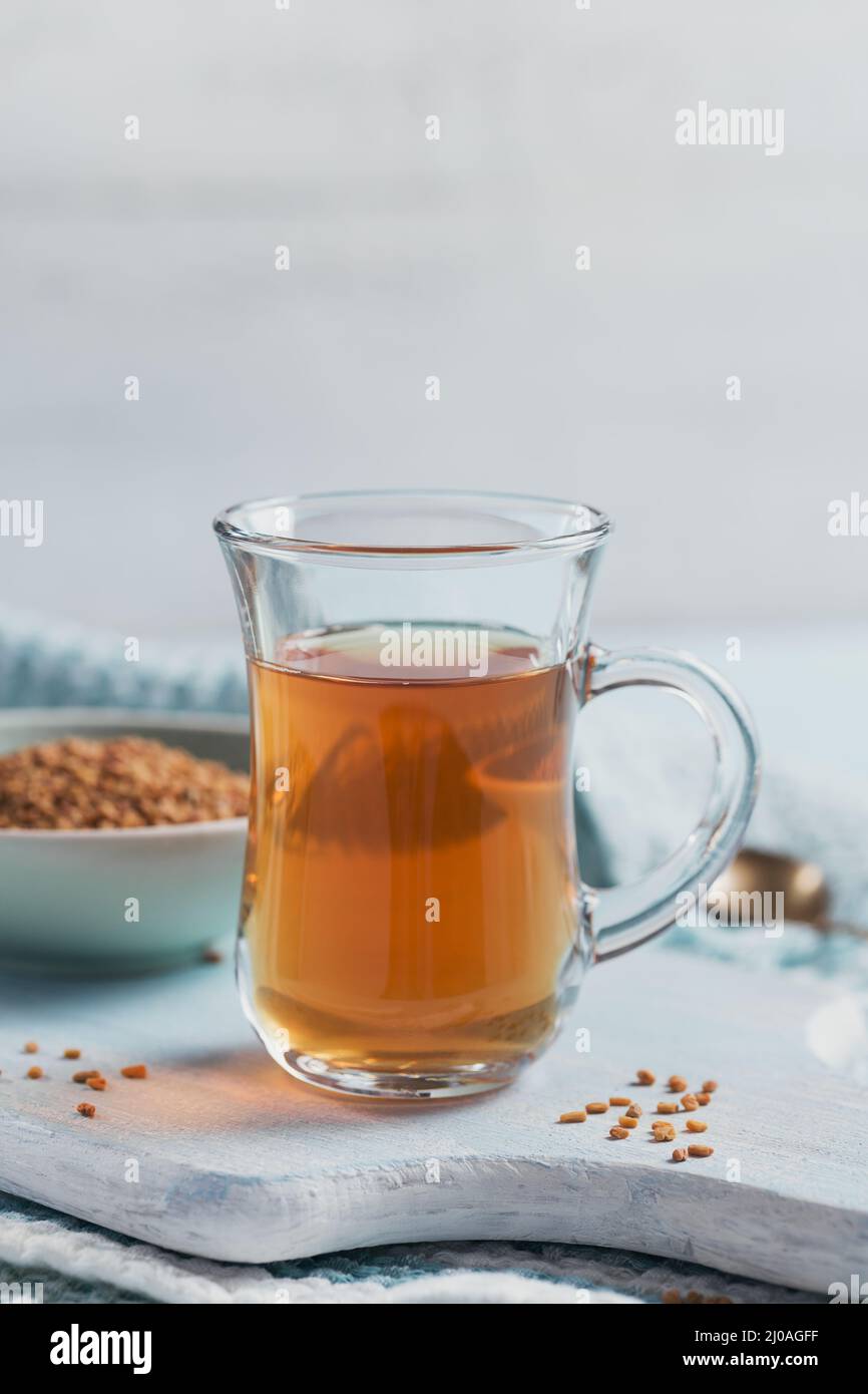 Glass cup of Egyptian fenugreek yellow tea, Helba or Methi Dana drink