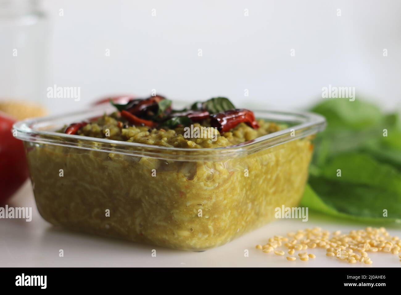One pot preparation made of basmati rice, yellow mung lentils, blanched and pureed spinach and spices. Commonly known as palak khichdi. Shot on white Stock Photo