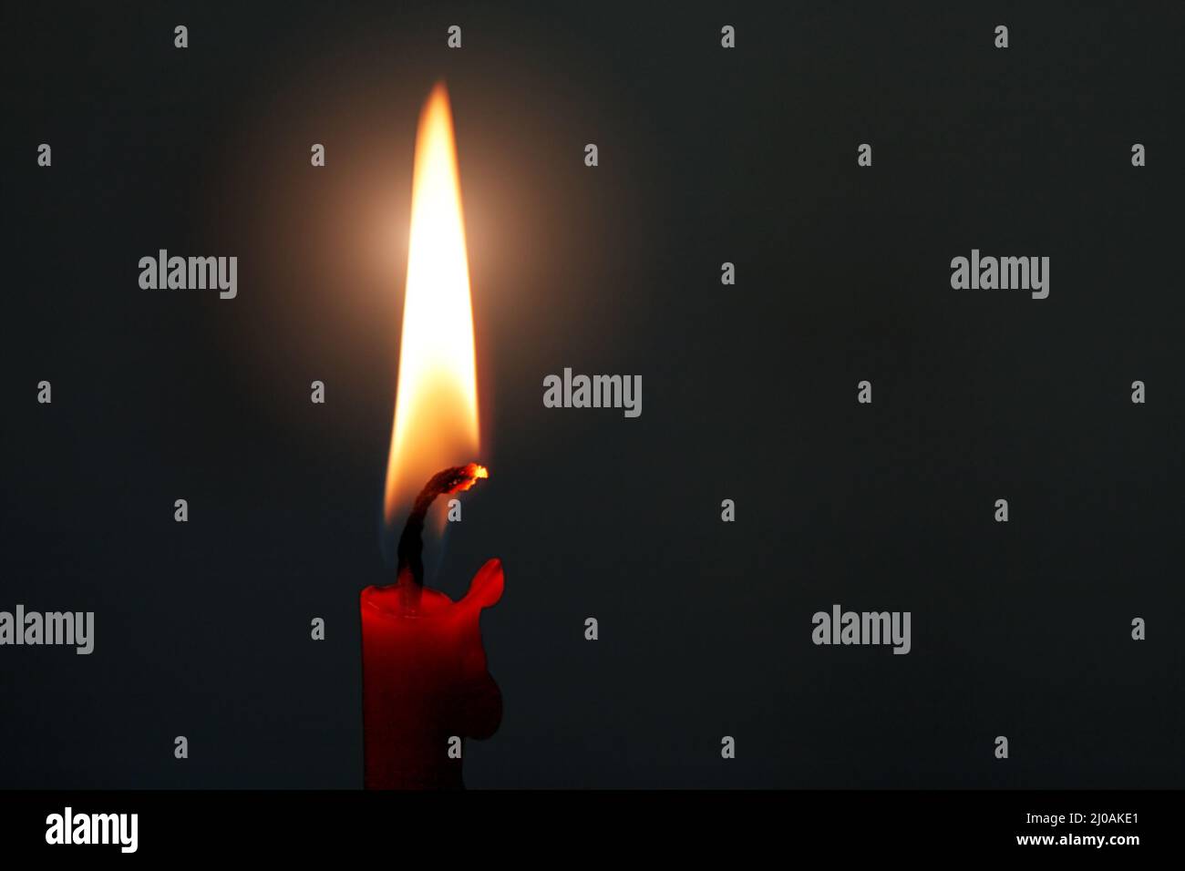 Burning red candle Stock Photo Alamy