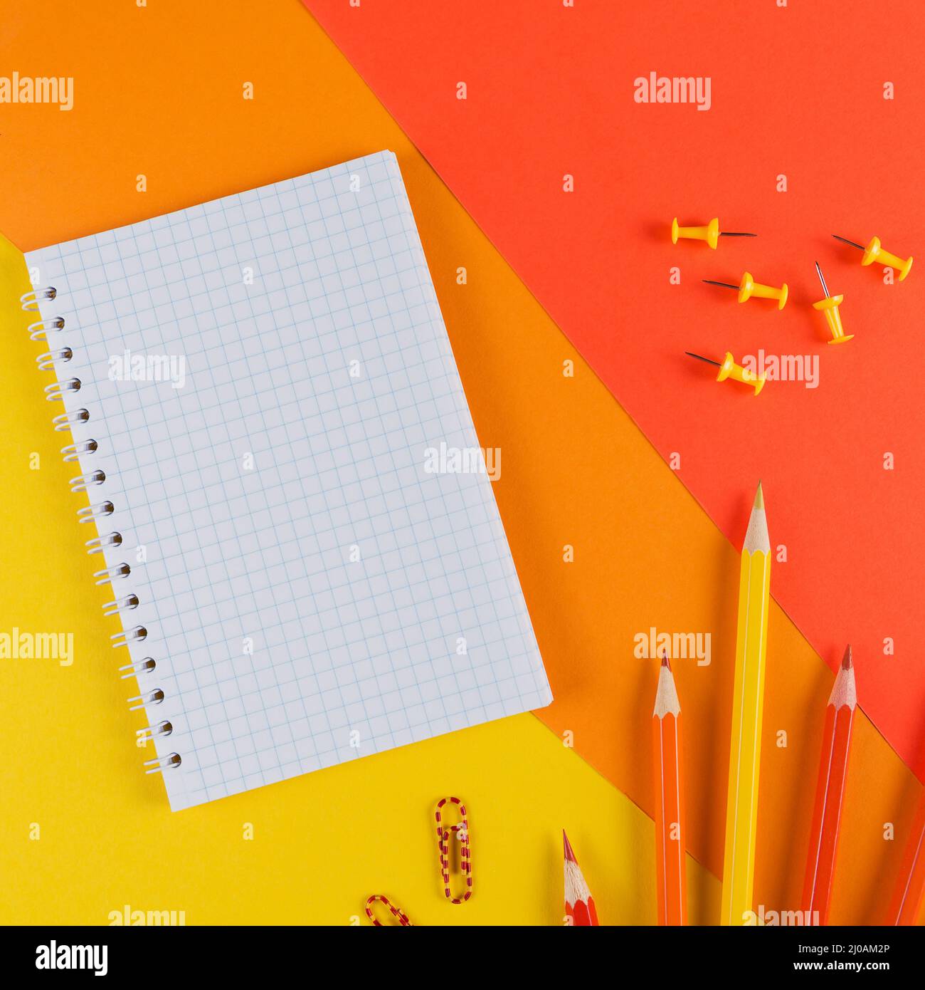 Yellow and orange office desk table with blank notebook and other