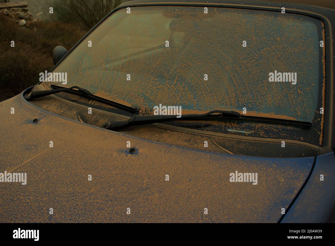 Orange dust deposit on car from exceptionally severe Saharan dust cloud in Almería province, southern Spain. 14-15 March 2022. Stock Photo